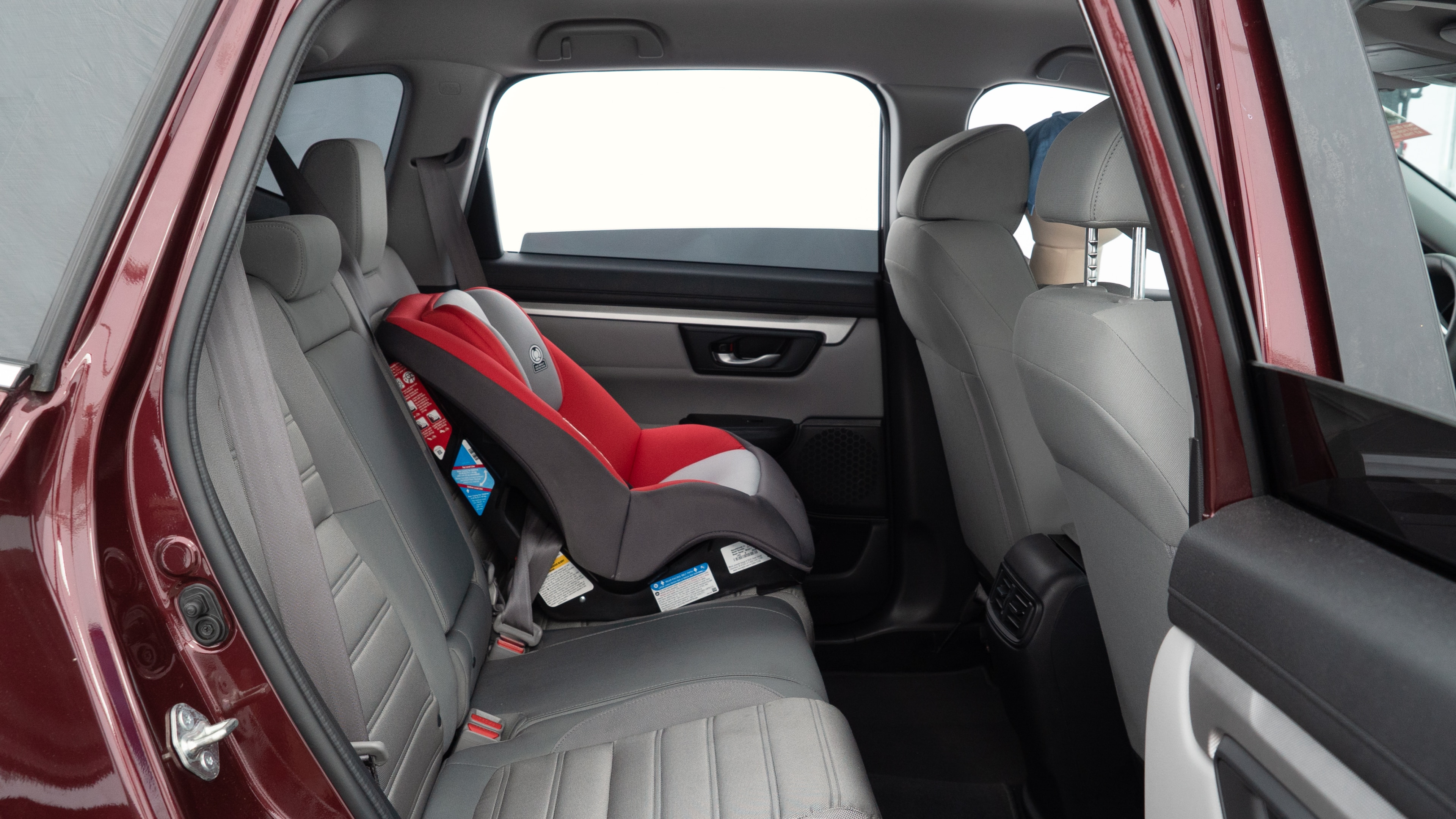 A series of second-row backseat photos is shown including one seating a baby seat and one seating a 6'1" mannequin.