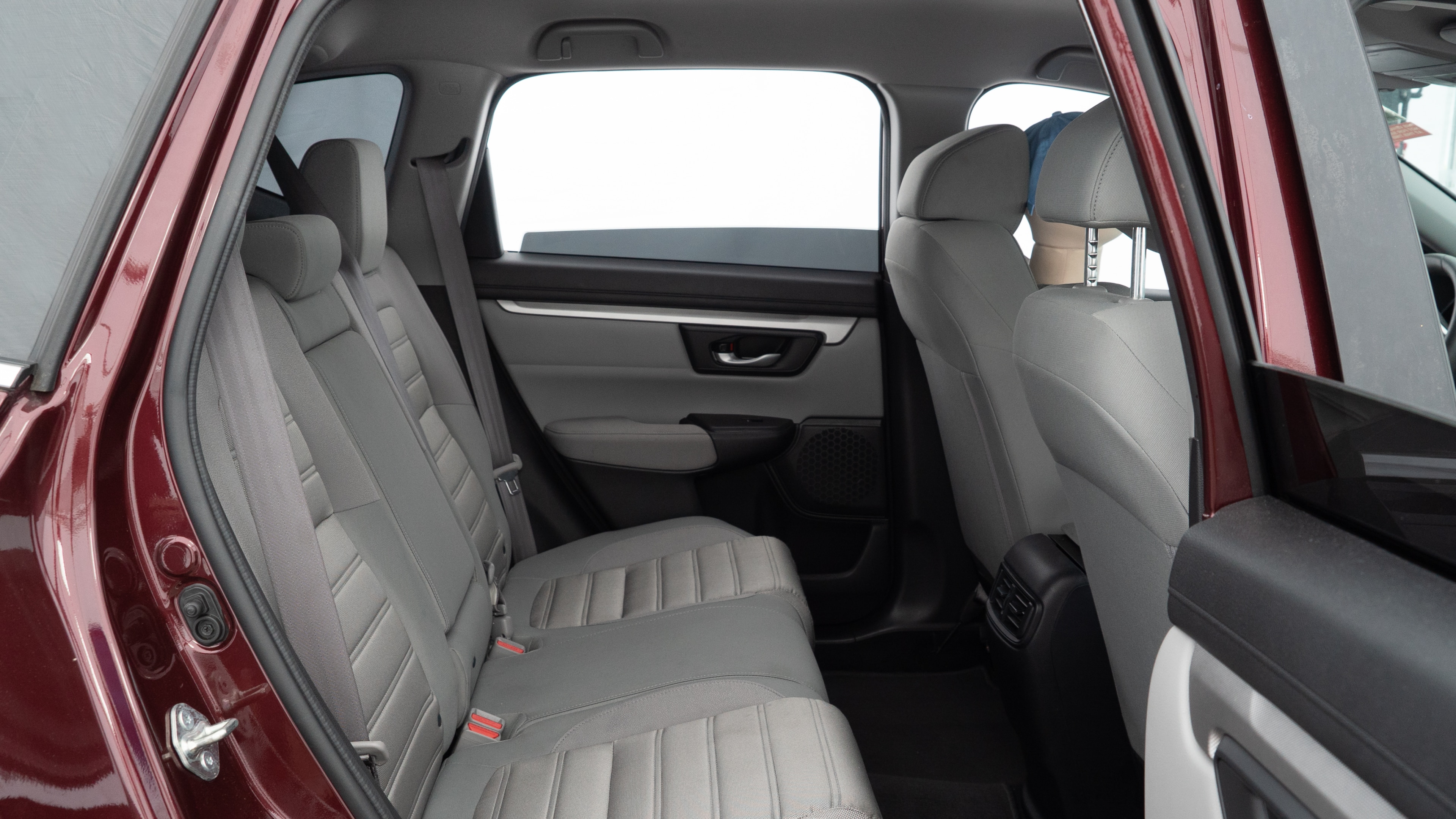 A series of second-row backseat photos is shown including one seating a baby seat and one seating a 6'1" mannequin.