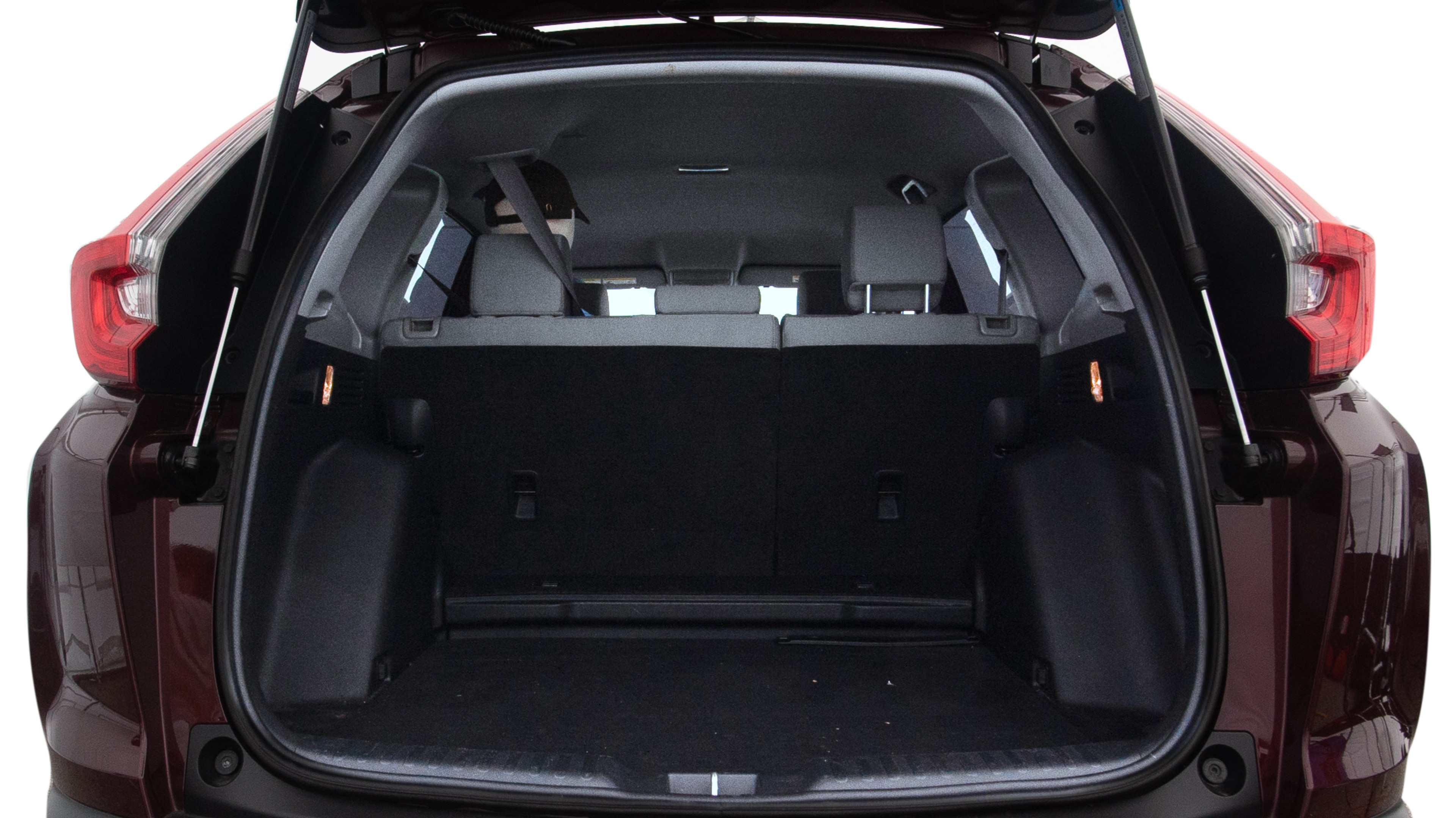 The trunk lid is open showing full view of the trunk. A baby stroller, three grocery carriers, two camping chairs in the carrying bag, and a set of golf clubs are placed inside.