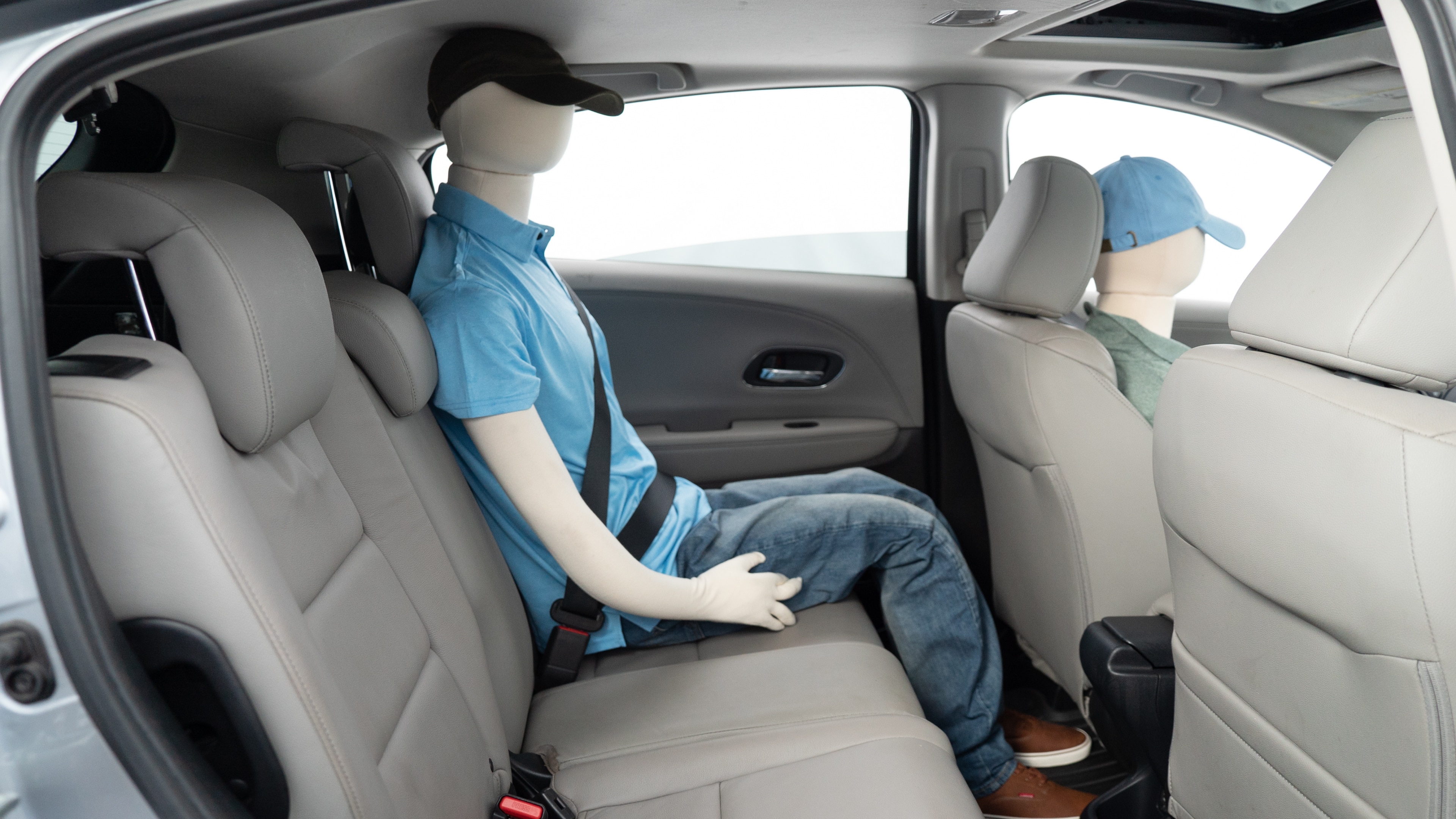 A series of second-row backseat photos is shown including one seating a baby seat, a dog and one seating a 6'1" mannequin.
