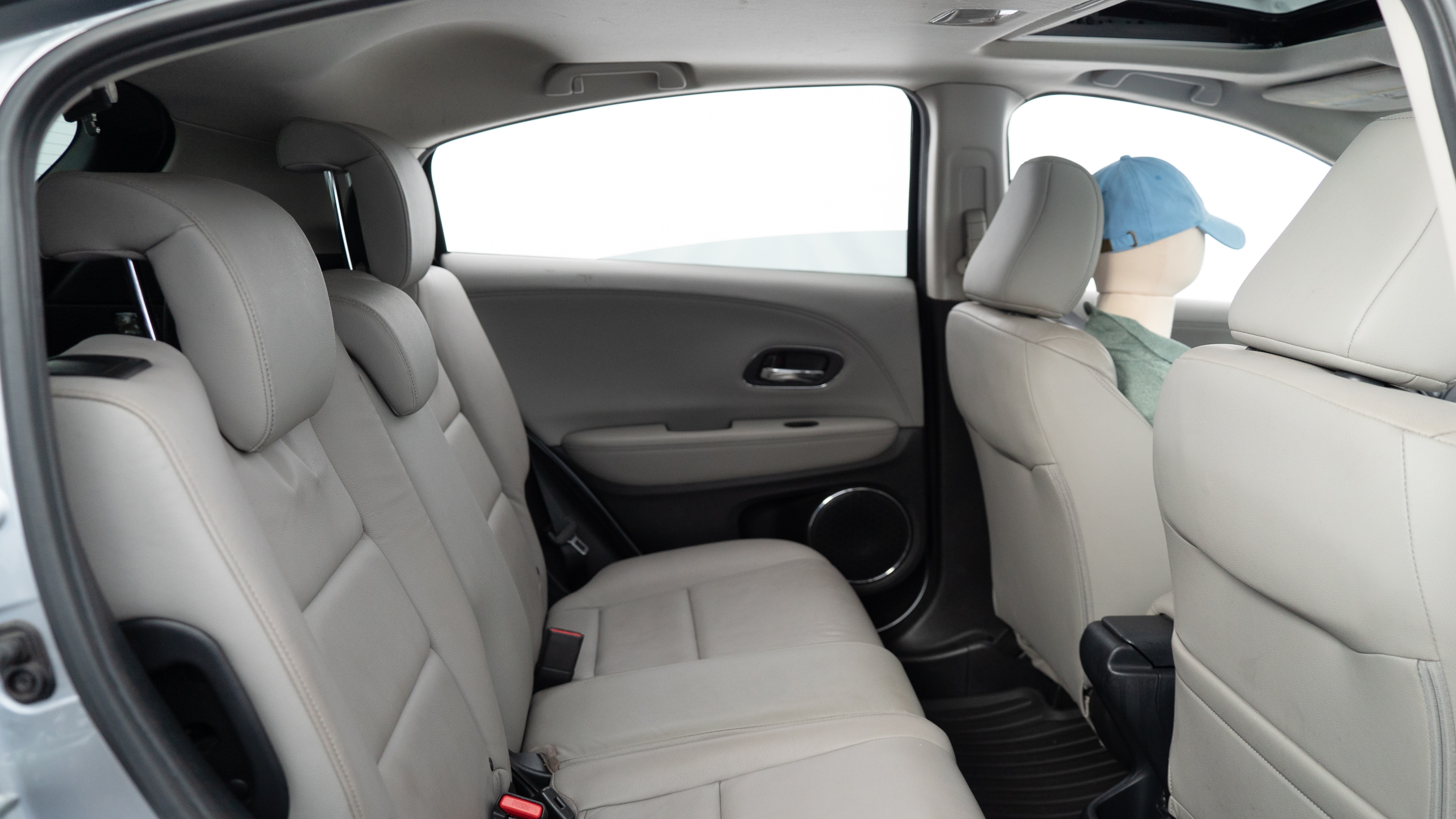 A series of second-row backseat photos is shown including one seating a baby seat, a dog and one seating a 6'1" mannequin.