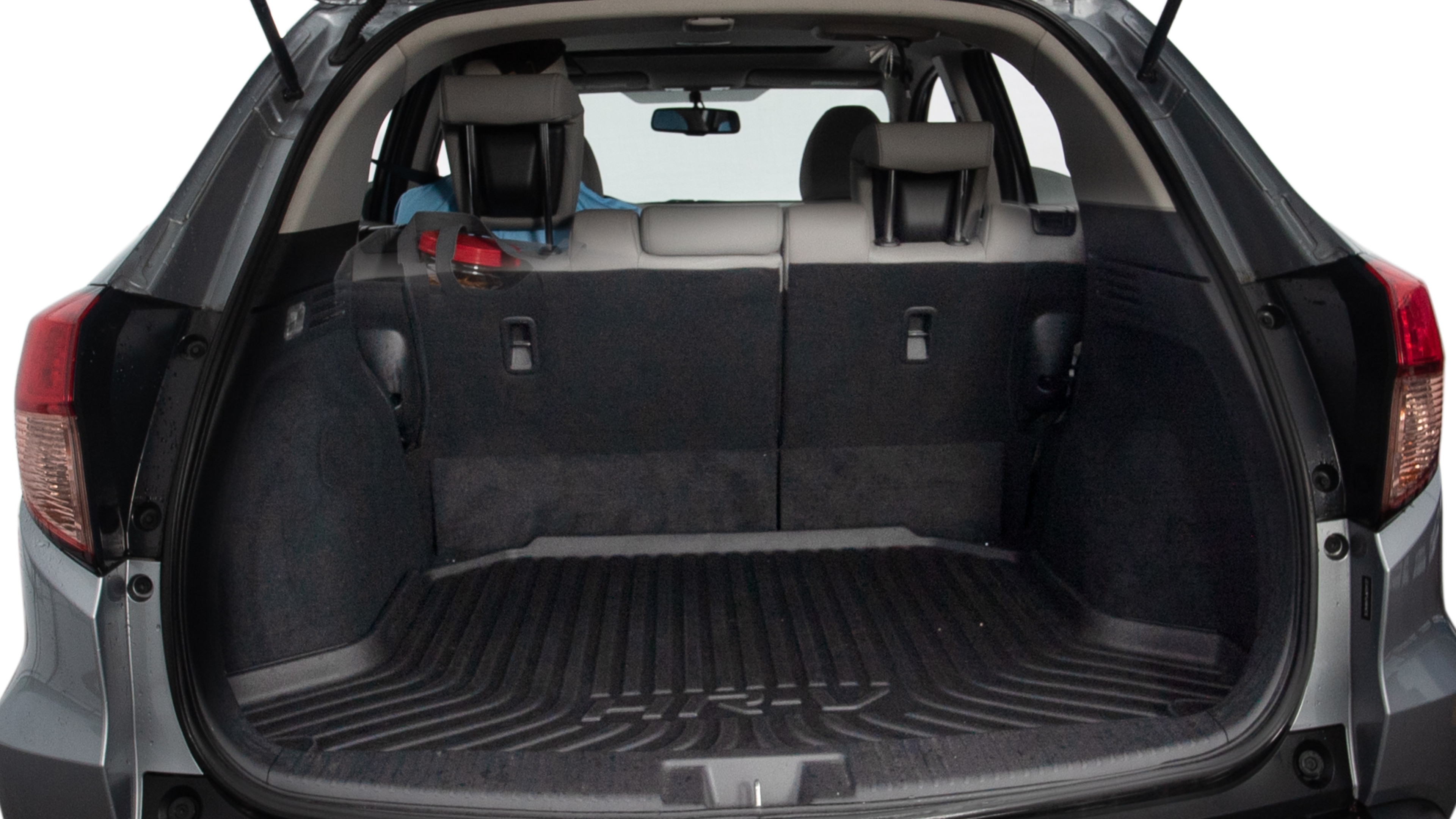The trunk lid is open showing full view of the trunk. A baby stroller, three grocery carriers, two camping chairs in the carrying bag, and a set of golf clubs are placed inside.