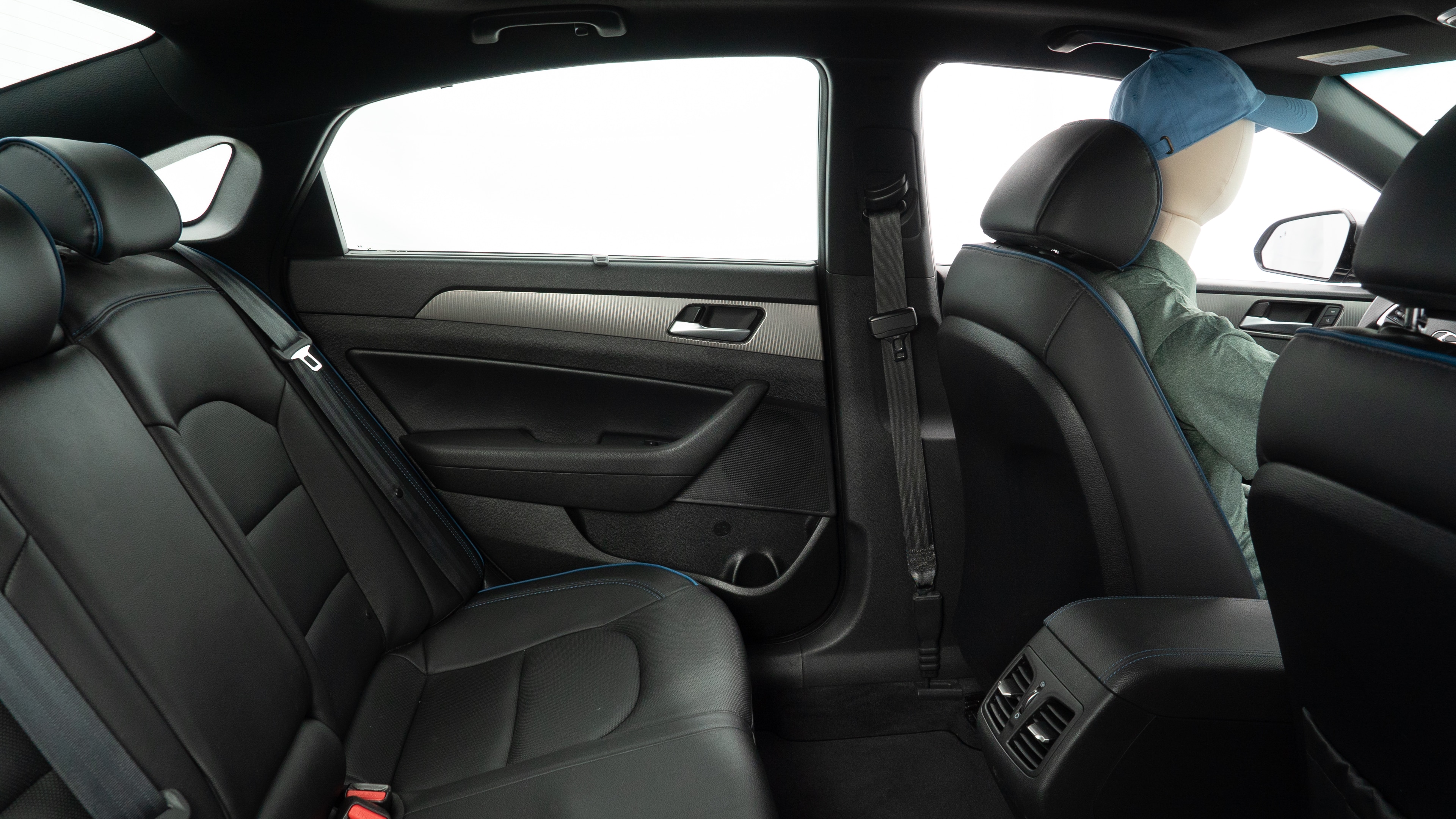 A series of second-row backseat photos is shown including one seating a baby seat and one seating a 6'1" mannequin.