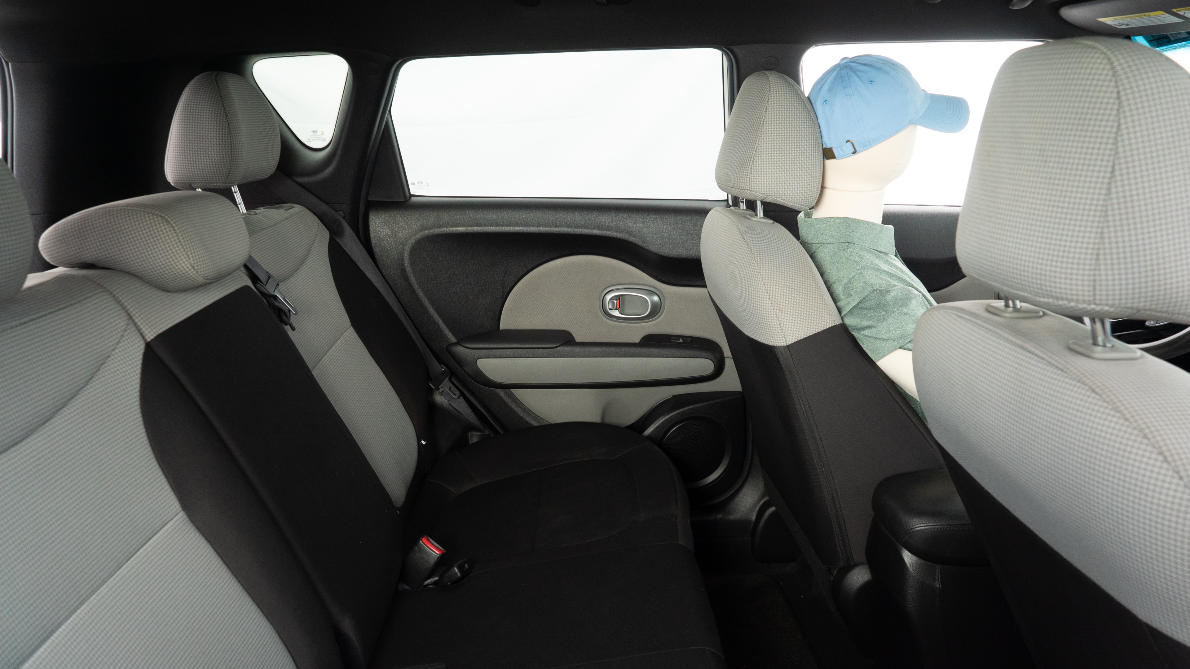 A series of second-row backseat photos is shown including one seating a baby seat and one seating a 6'1" mannequin.