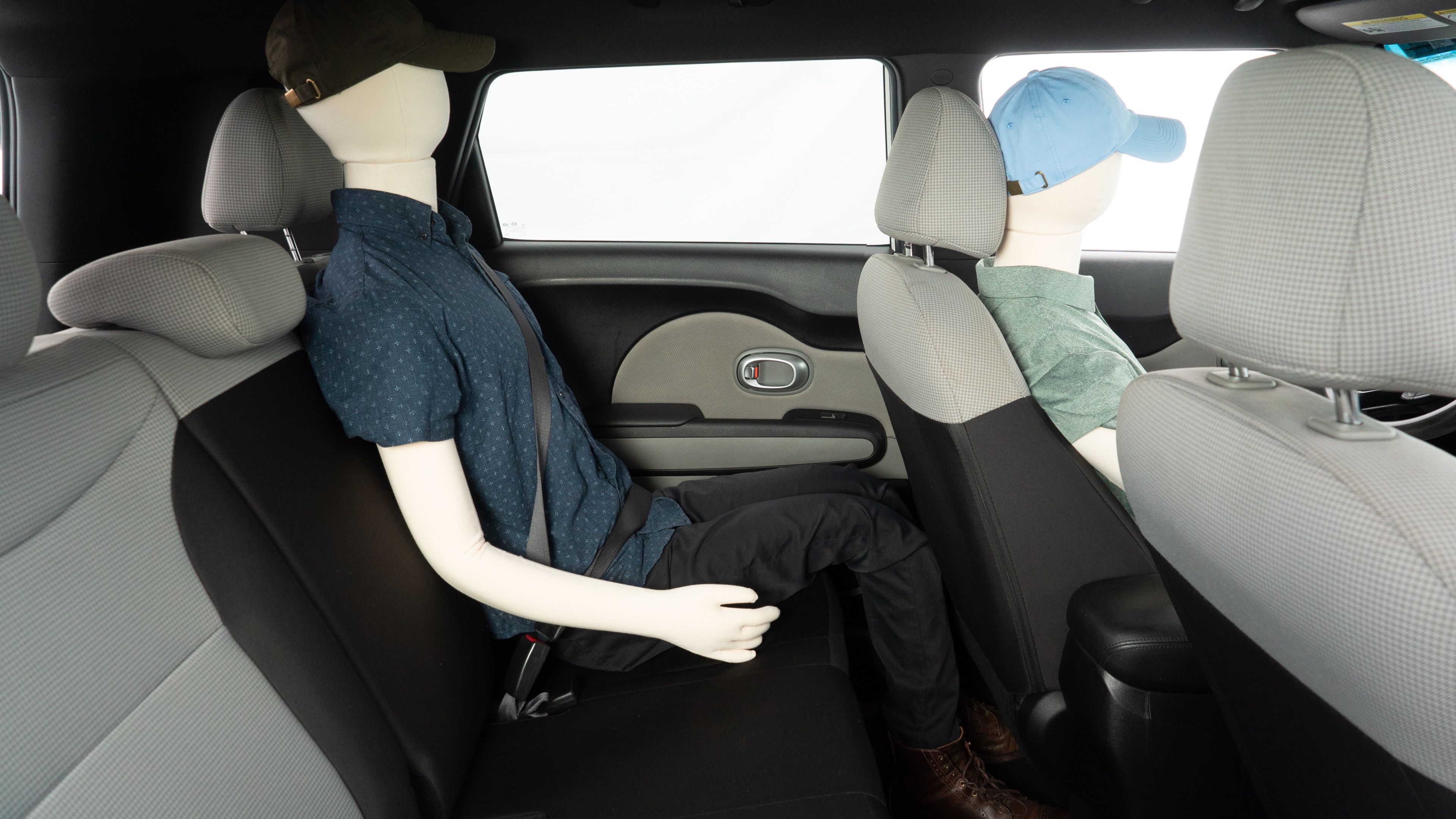 A series of second-row backseat photos is shown including one seating a baby seat and one seating a 6'1" mannequin.