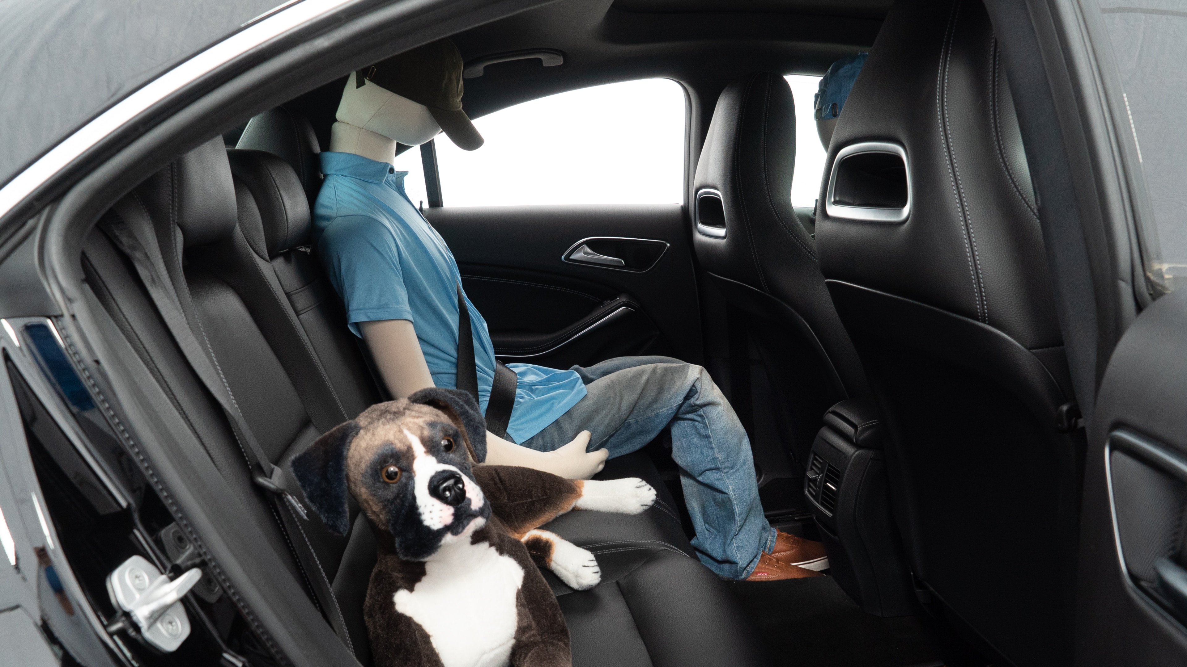A series of second-row backseat photos is shown including one seating a baby seat and one seating a 6'1" mannequin.
