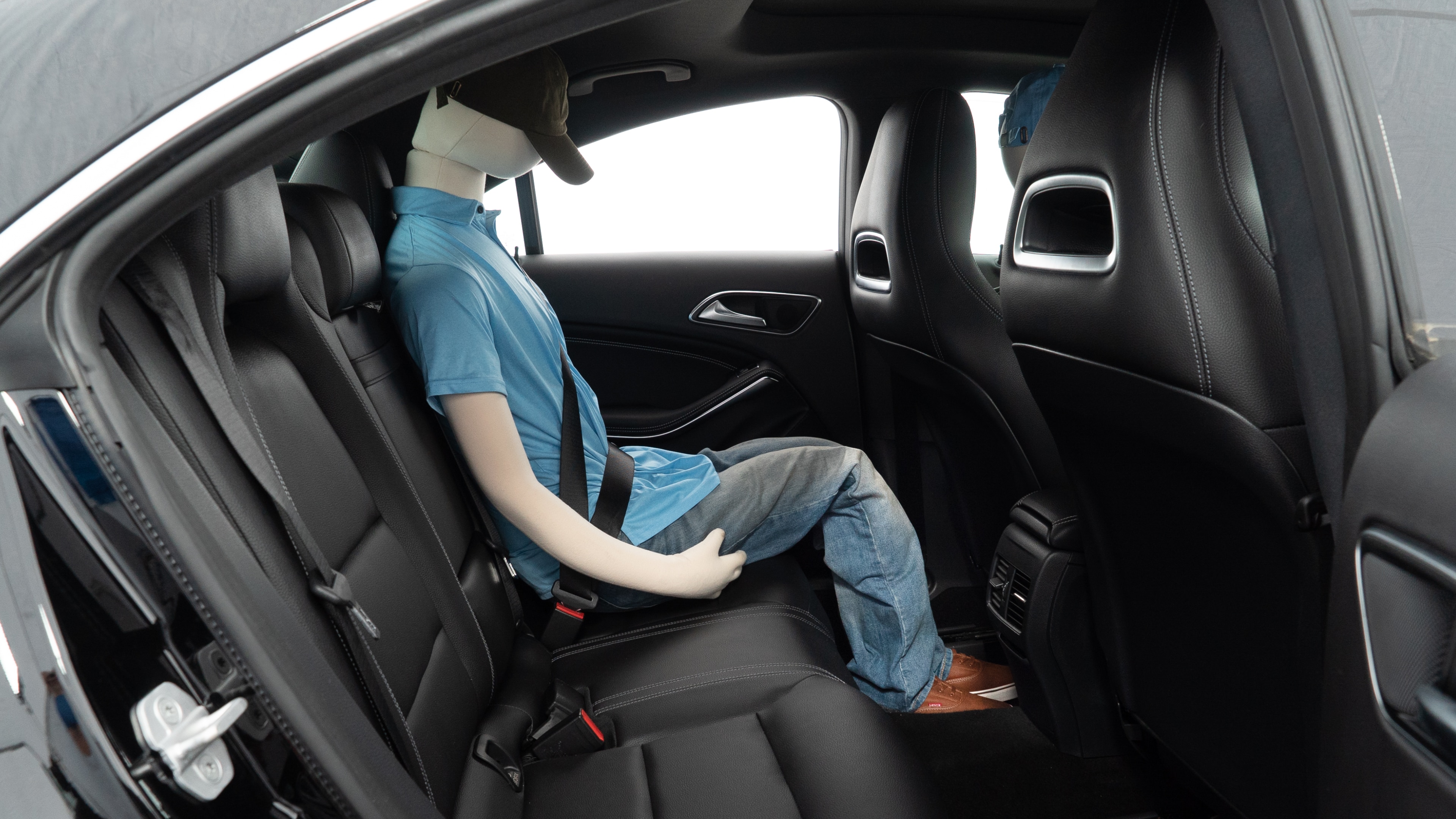 A series of second-row backseat photos is shown including one seating a baby seat and one seating a 6'1" mannequin.