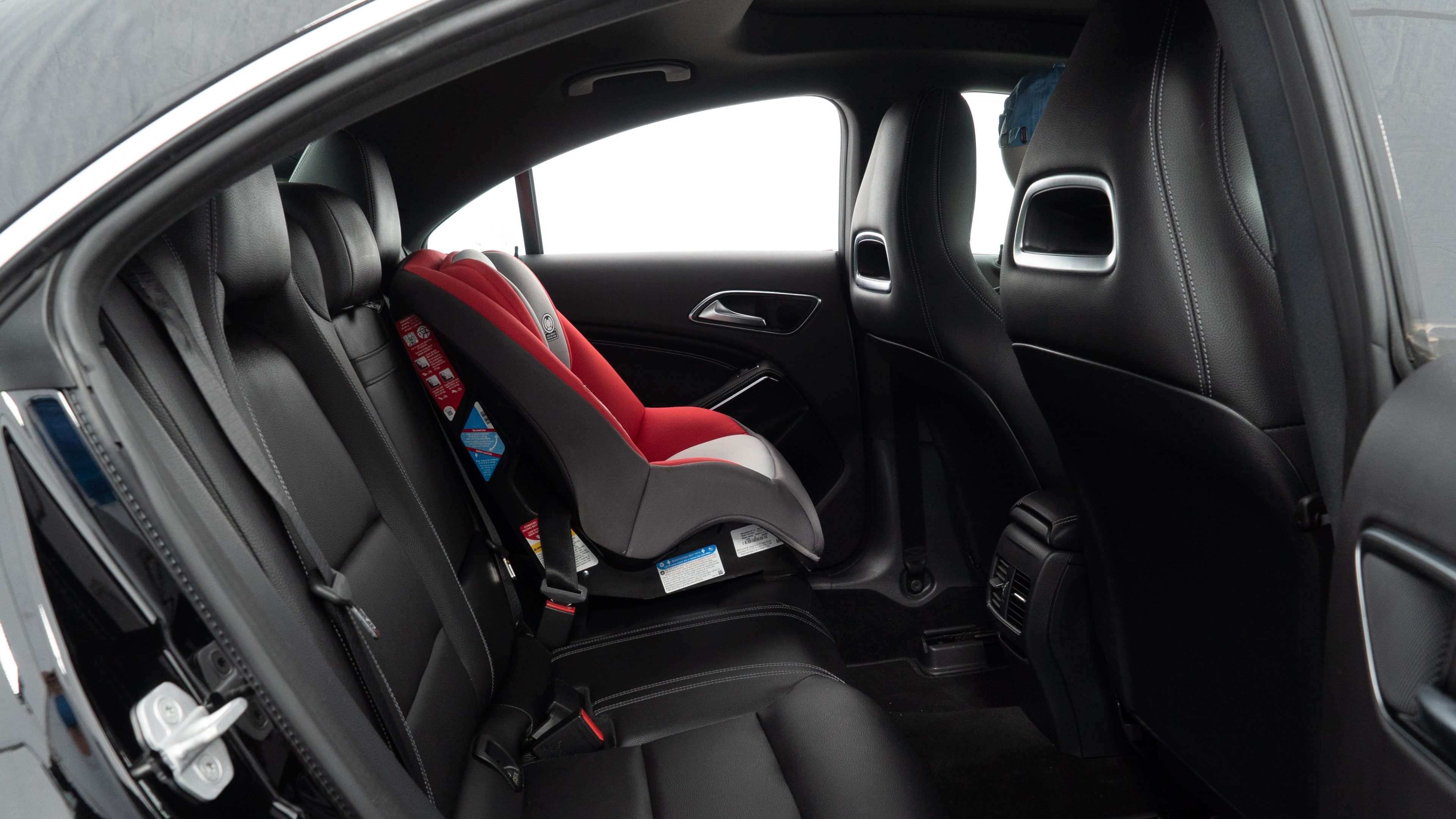 A series of second-row backseat photos is shown including one seating a baby seat and one seating a 6'1" mannequin.