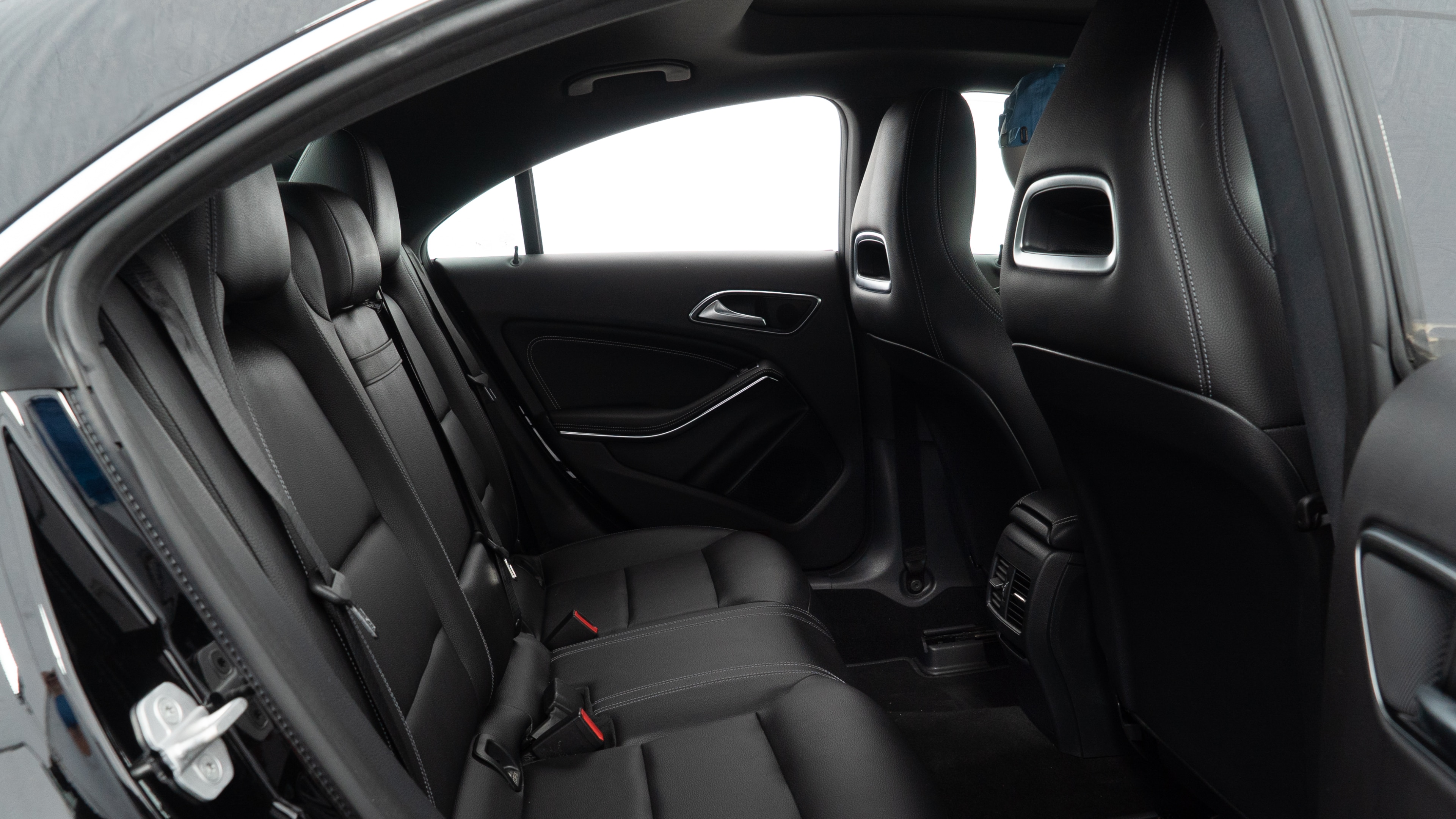 A series of second-row backseat photos is shown including one seating a baby seat and one seating a 6'1" mannequin.