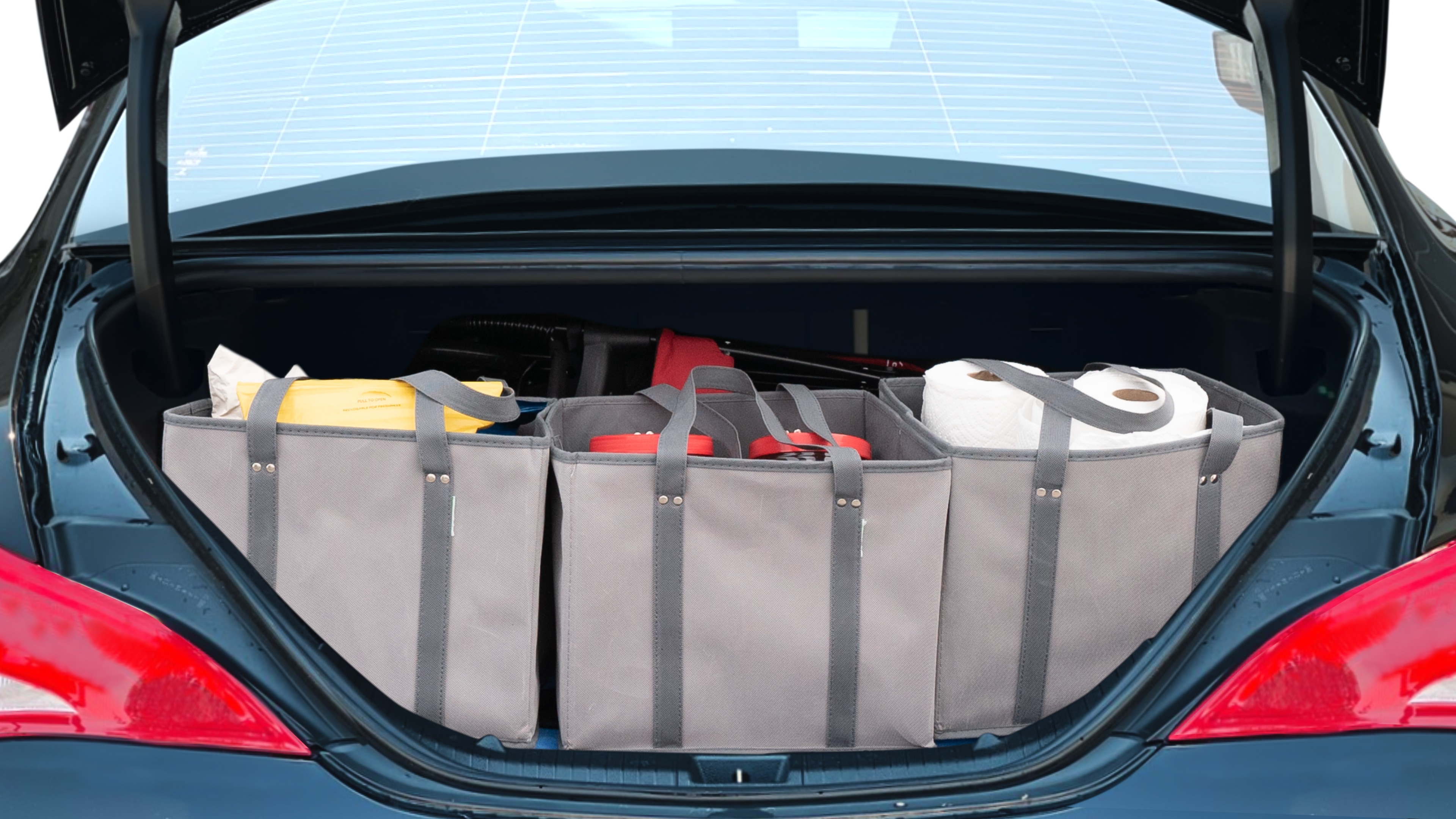 The trunk lid is open showing full view of the trunk. A baby stroller, three grocery carriers, two camping chairs in the carrying bag, and a set of golf clubs are placed inside.
