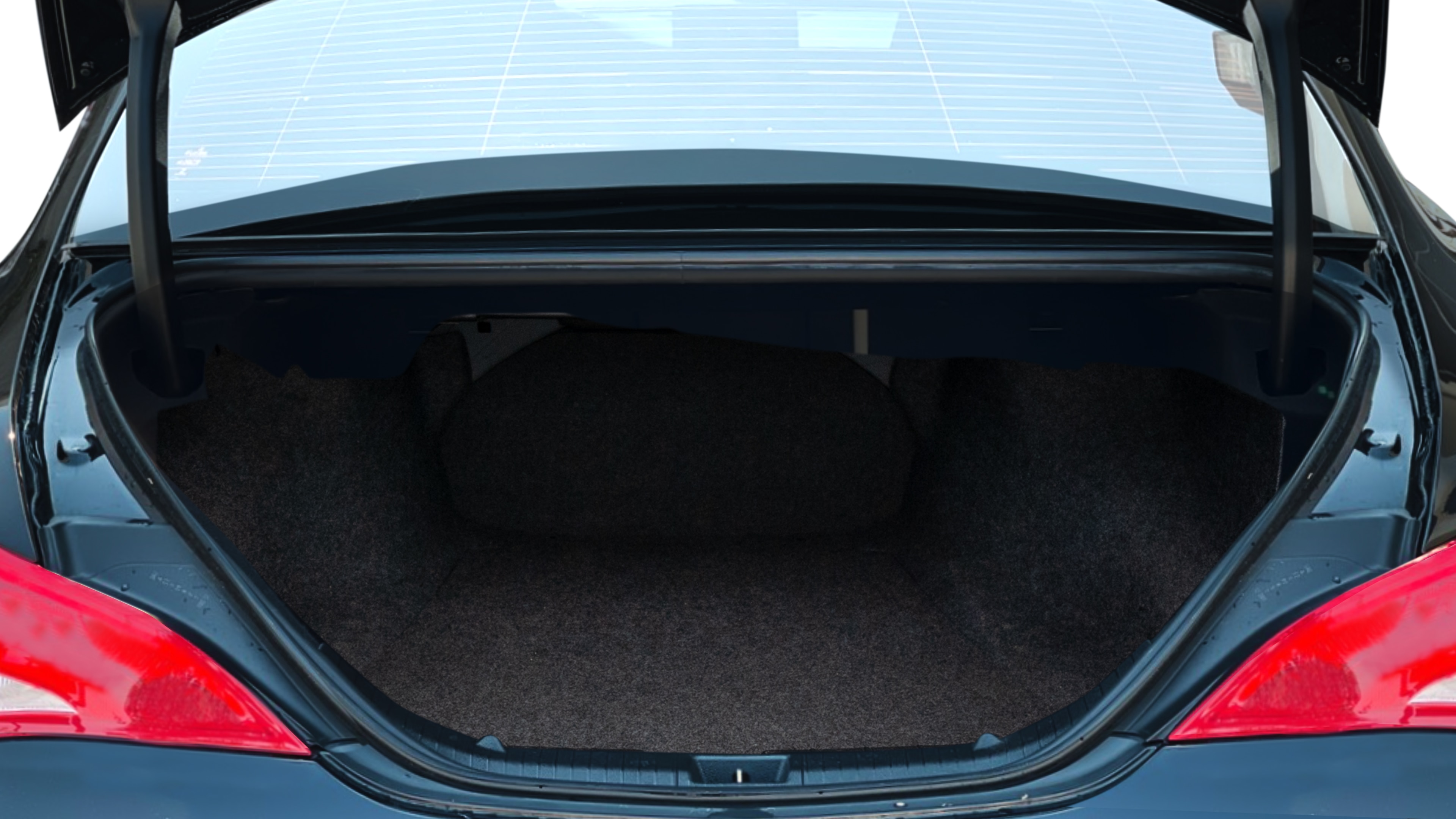 The trunk lid is open showing full view of the trunk. A baby stroller, three grocery carriers, two camping chairs in the carrying bag, and a set of golf clubs are placed inside.