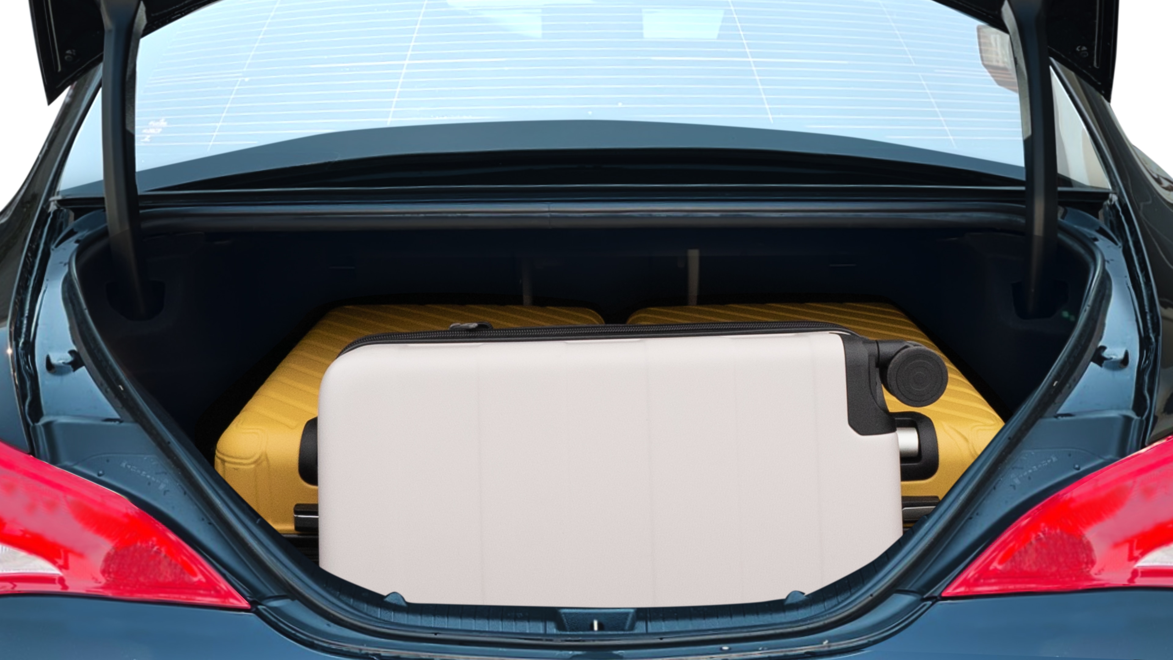 The trunk lid is open, showing full view of the trunk space. One large and two medium suitcases are placed inside.