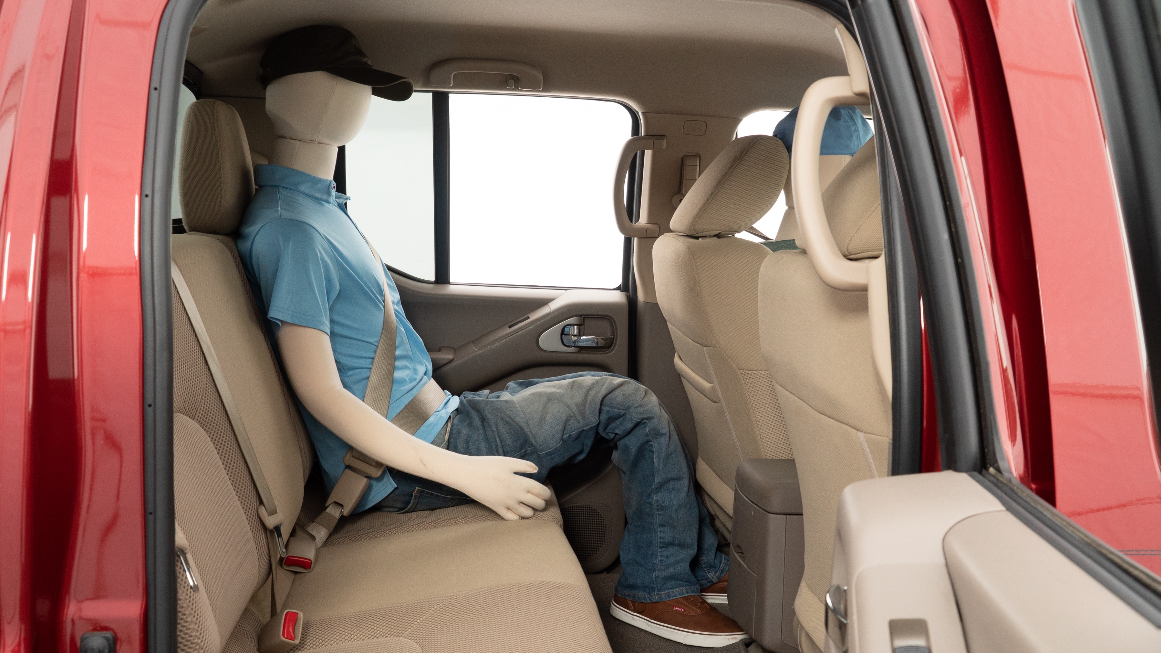 A series of second-row backseat photos is shown including one seating a baby seat and one seating a 6'1" mannequin.