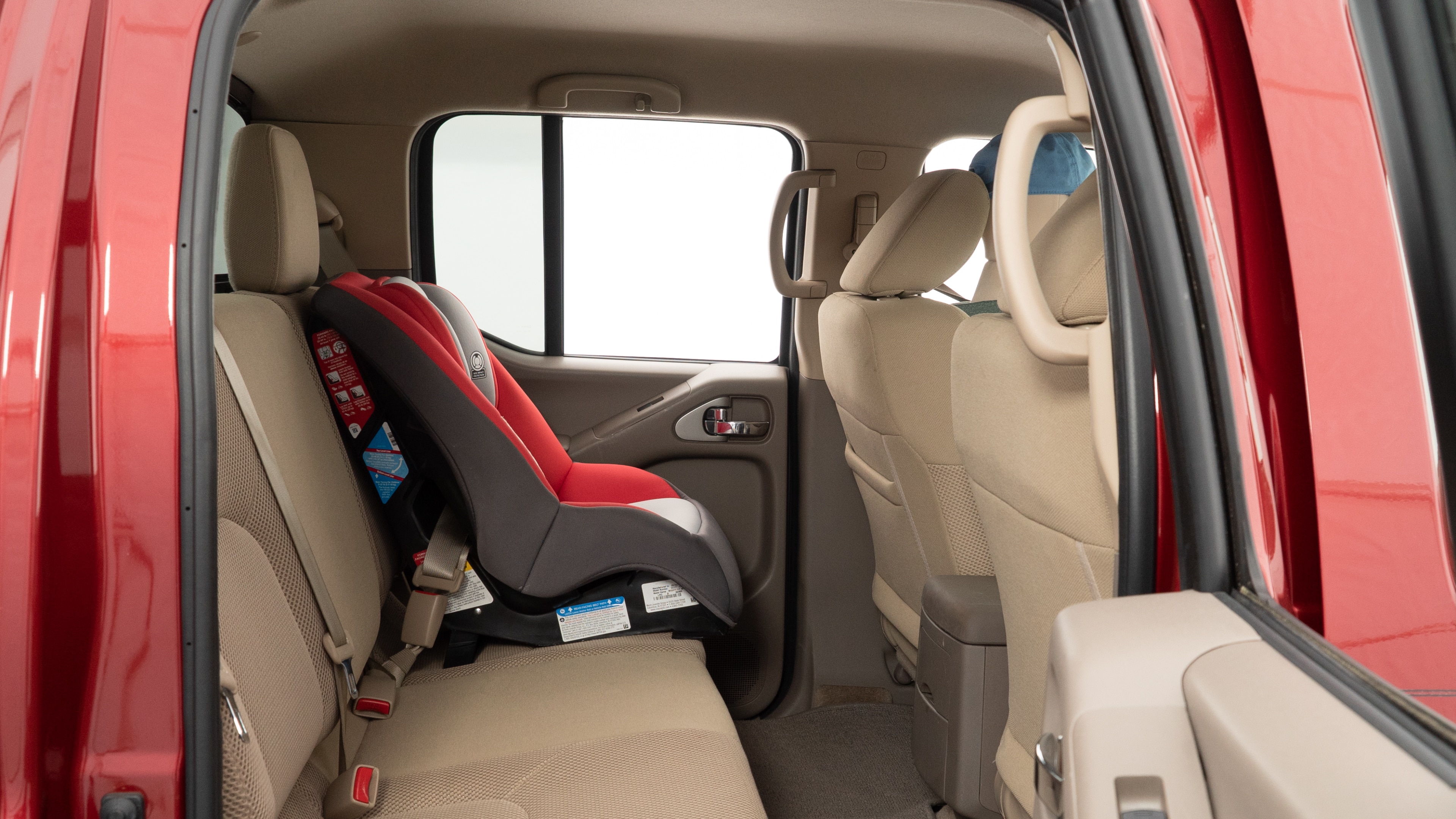 A series of second-row backseat photos is shown including one seating a baby seat and one seating a 6'1" mannequin.