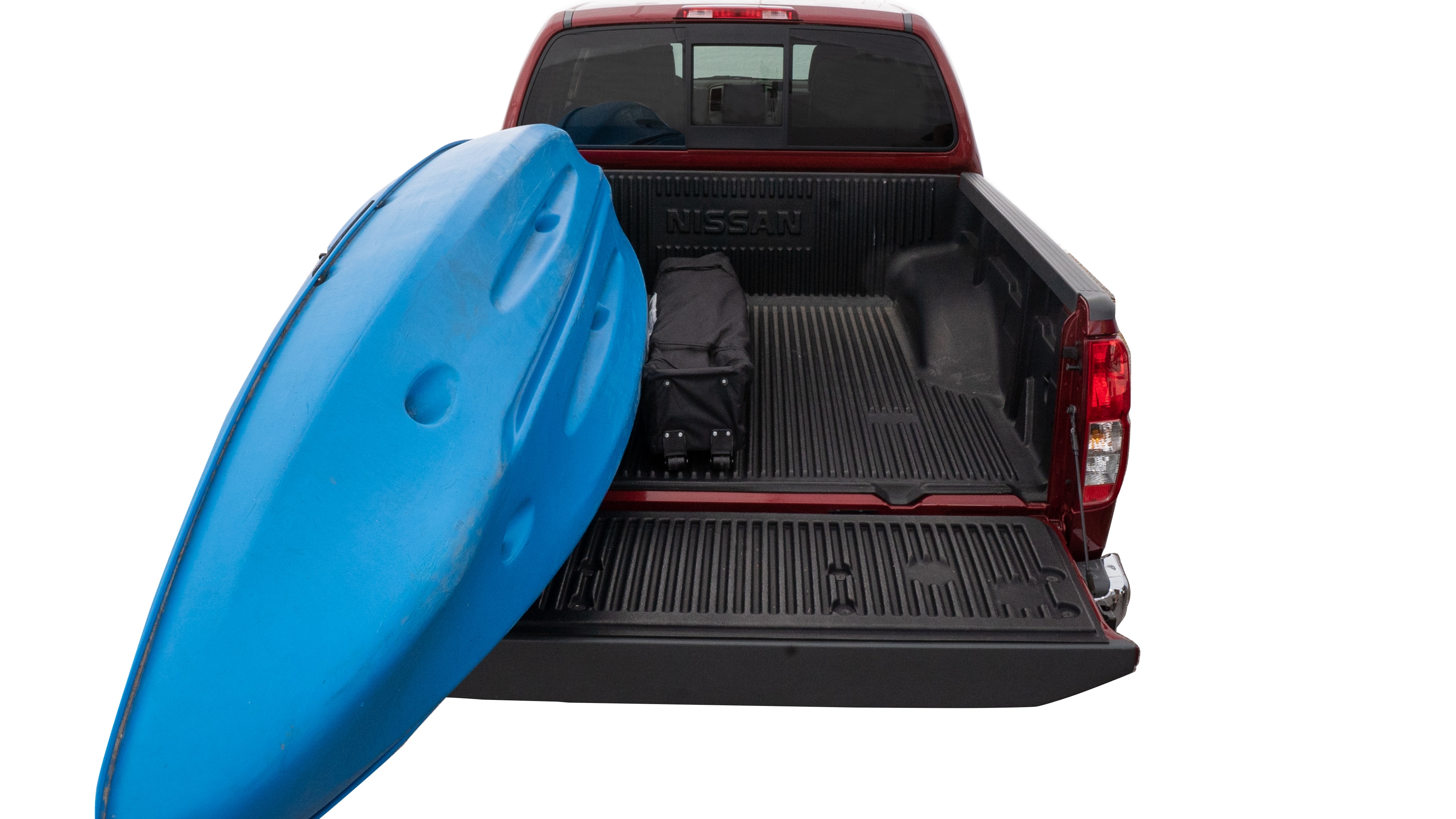 The trunk area is open giving a full view of the trunk area. A cooler, two camping chairs, a tailgate tent and a kayak are placed inside. 