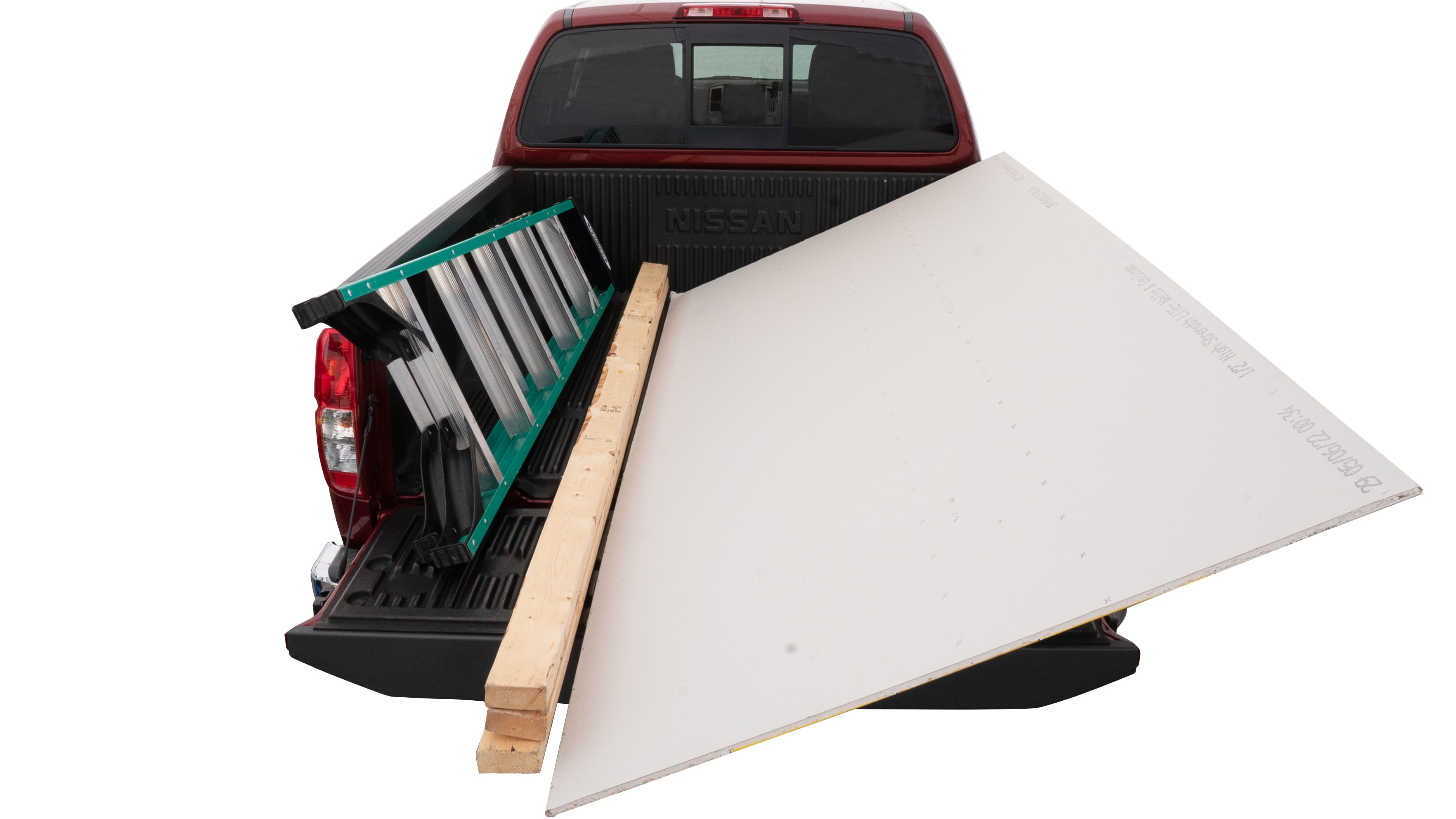 The trunk area is open giving a full view of the trunk area. A ladder, three 2 by 4 framing studs, two tool boxes and a 4 by 8 drywall sheet are placed inside. 