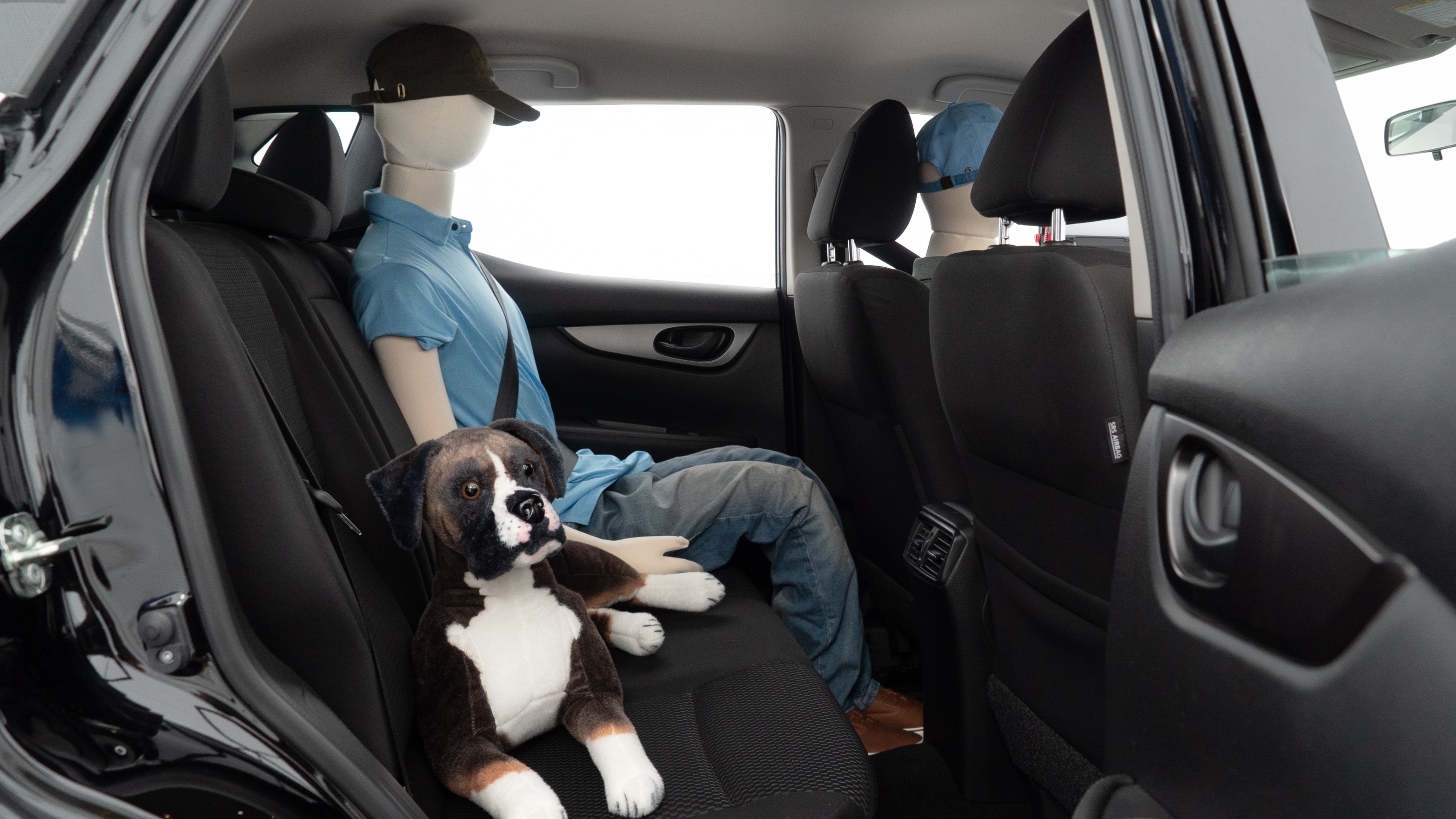 A series of second-row backseat photos is shown including one seating a baby seat and one seating a 6'1" mannequin.