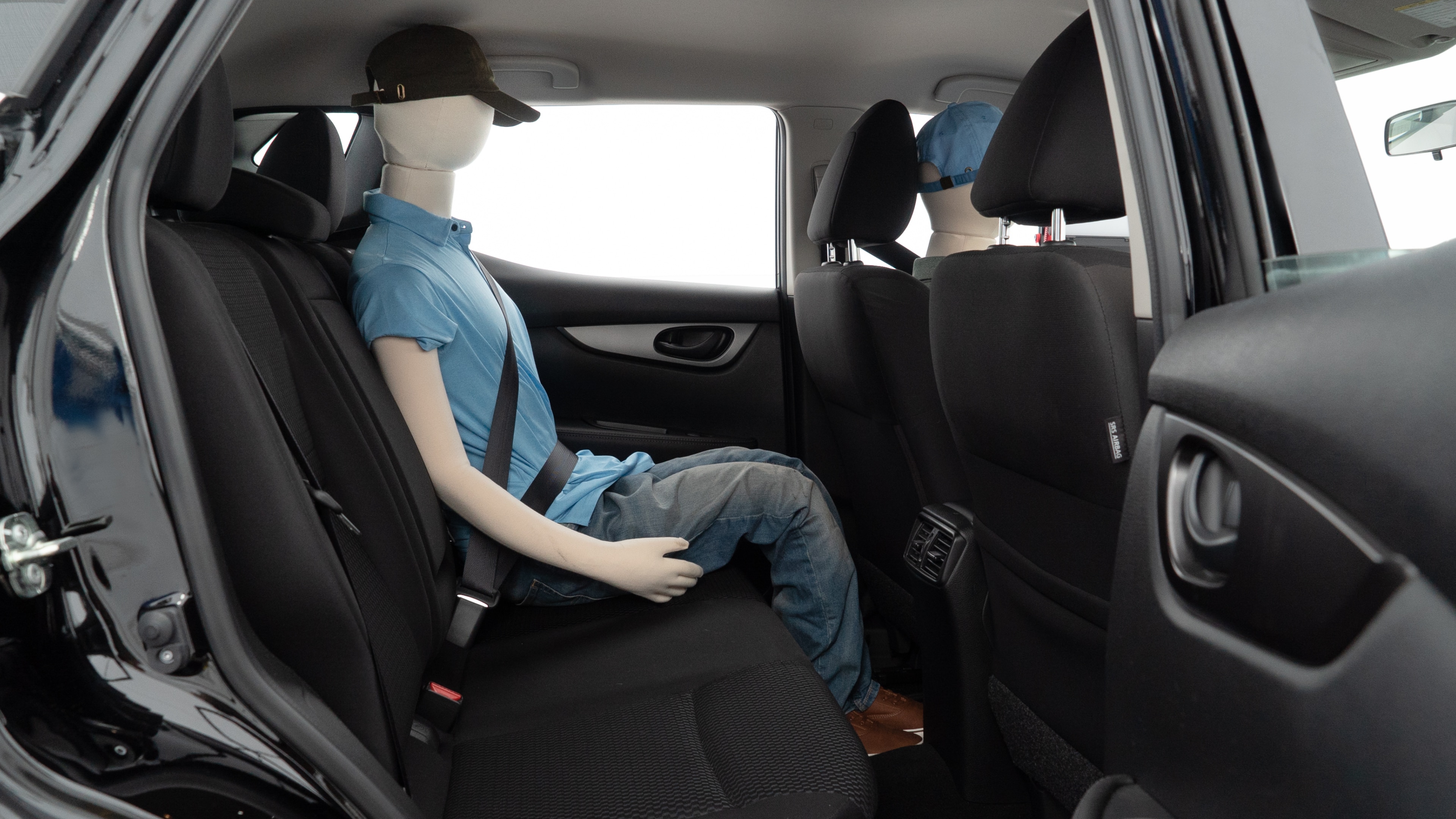 A series of second-row backseat photos is shown including one seating a baby seat and one seating a 6'1" mannequin.