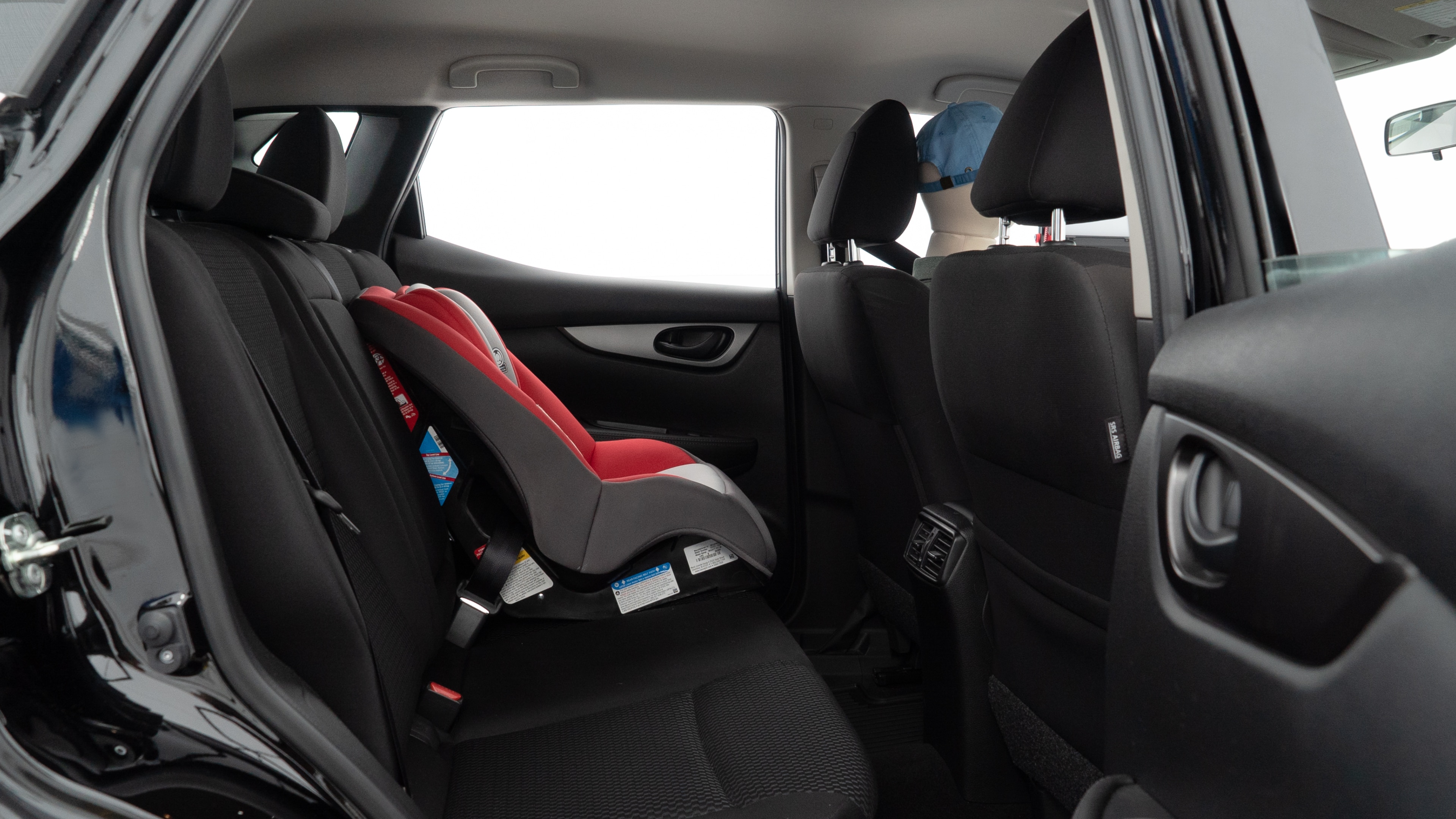 A series of second-row backseat photos is shown including one seating a baby seat and one seating a 6'1" mannequin.