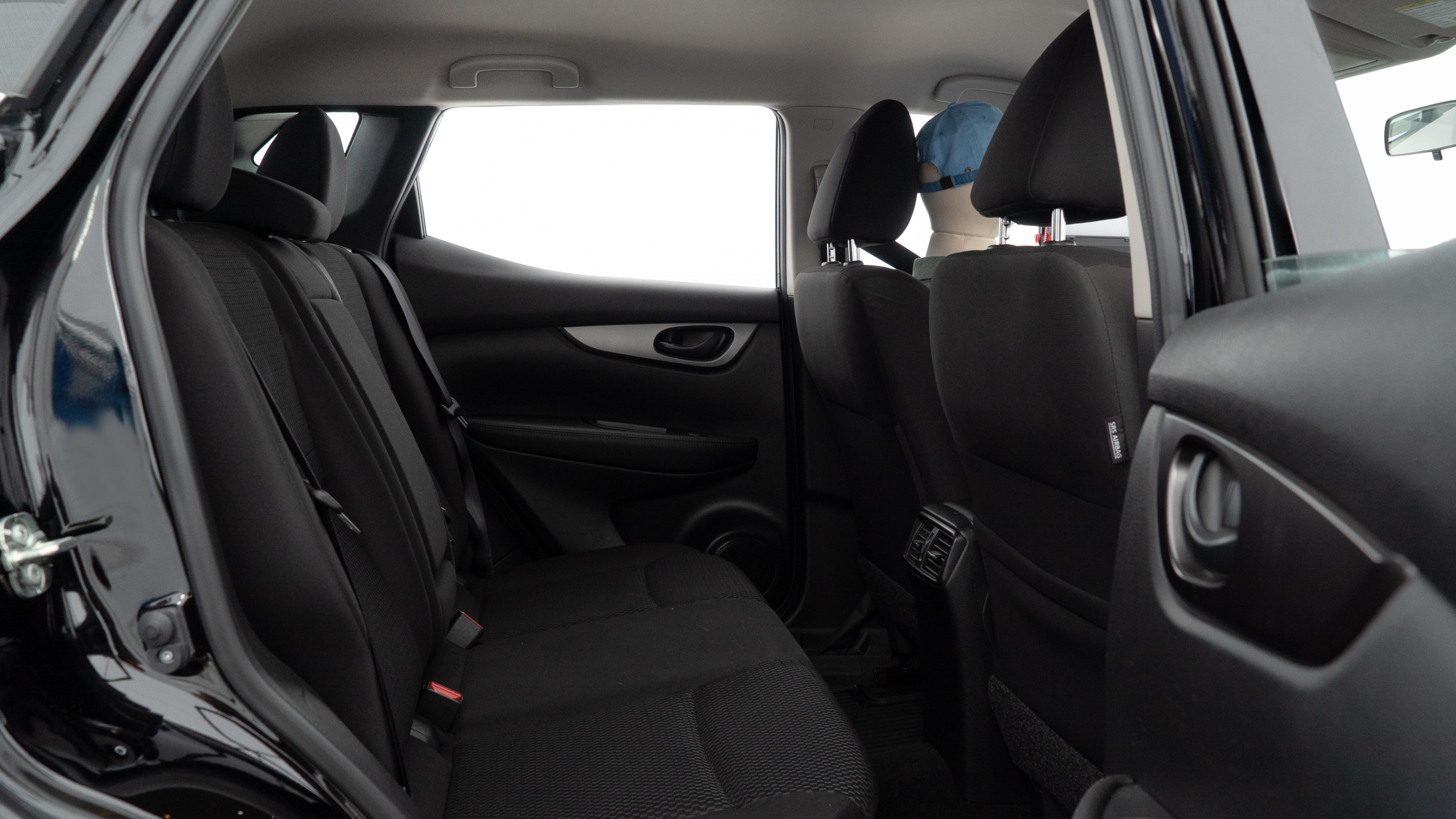 A series of second-row backseat photos is shown including one seating a baby seat and one seating a 6'1" mannequin.