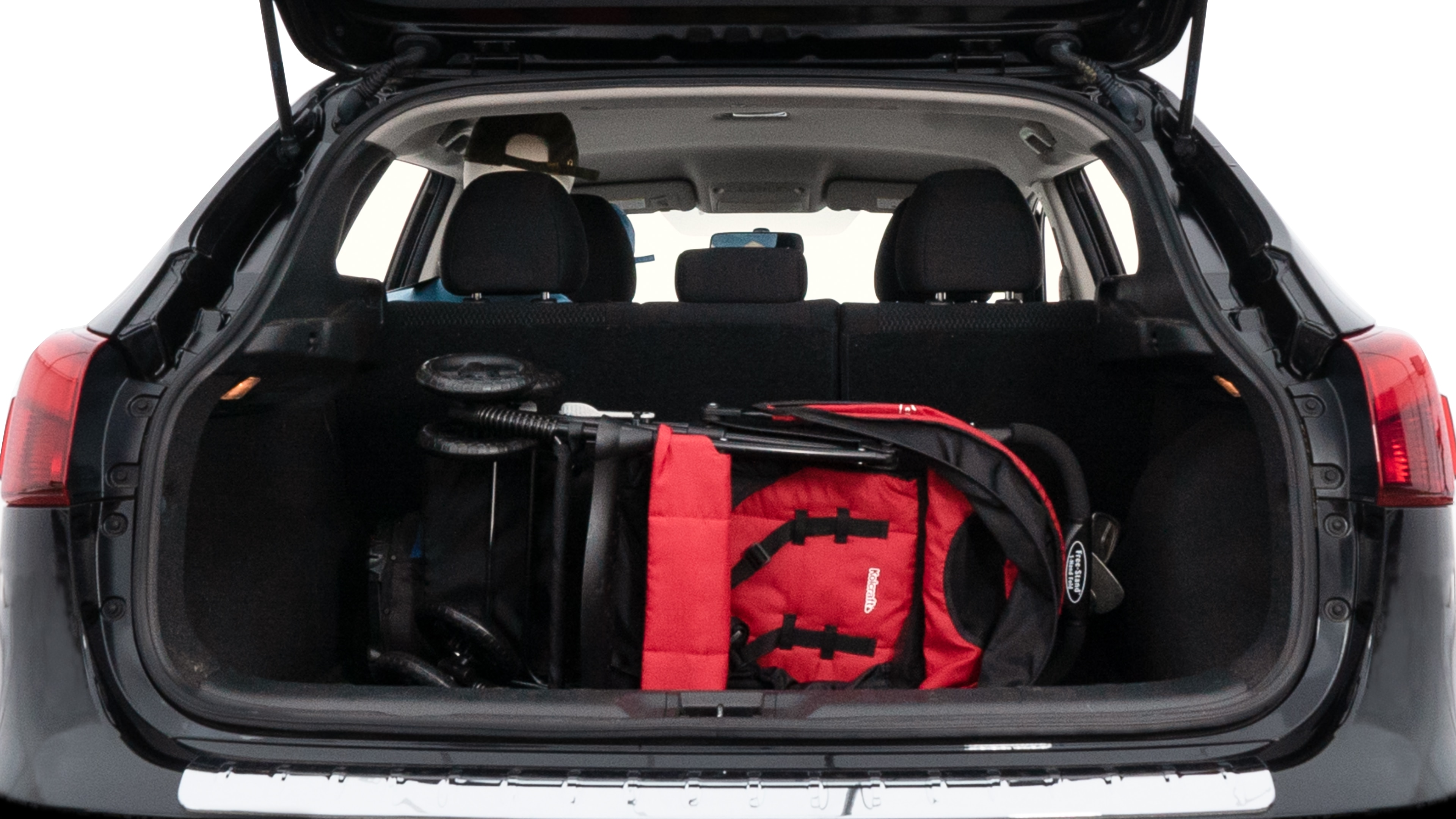 The trunk lid is open showing full view of the trunk. A baby stroller, three grocery carriers, two camping chairs in the carrying bag, and a set of golf clubs are placed inside.