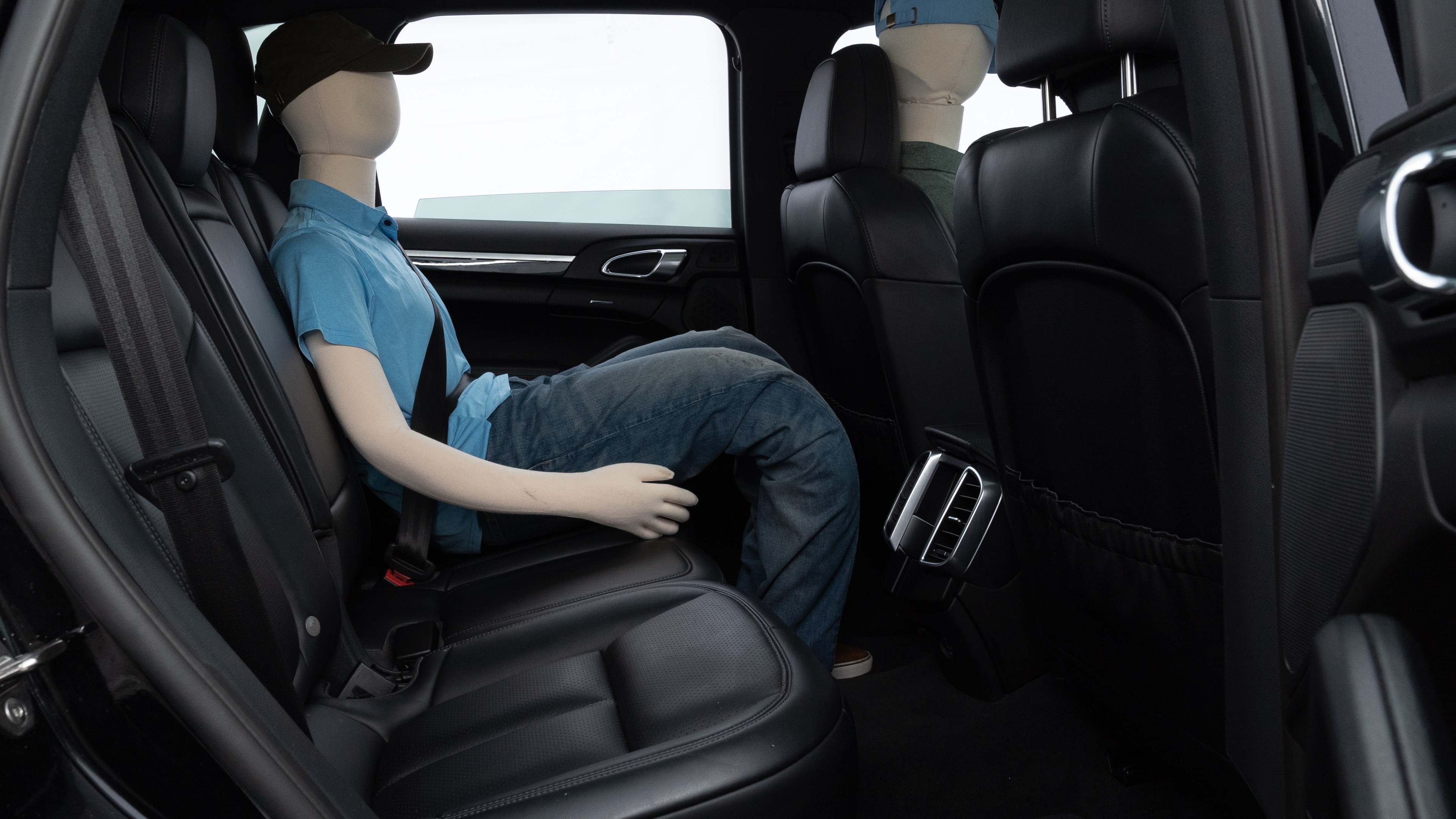 A series of second-row backseat photos is shown including one seating a baby seat and one seating a 6'1" mannequin.