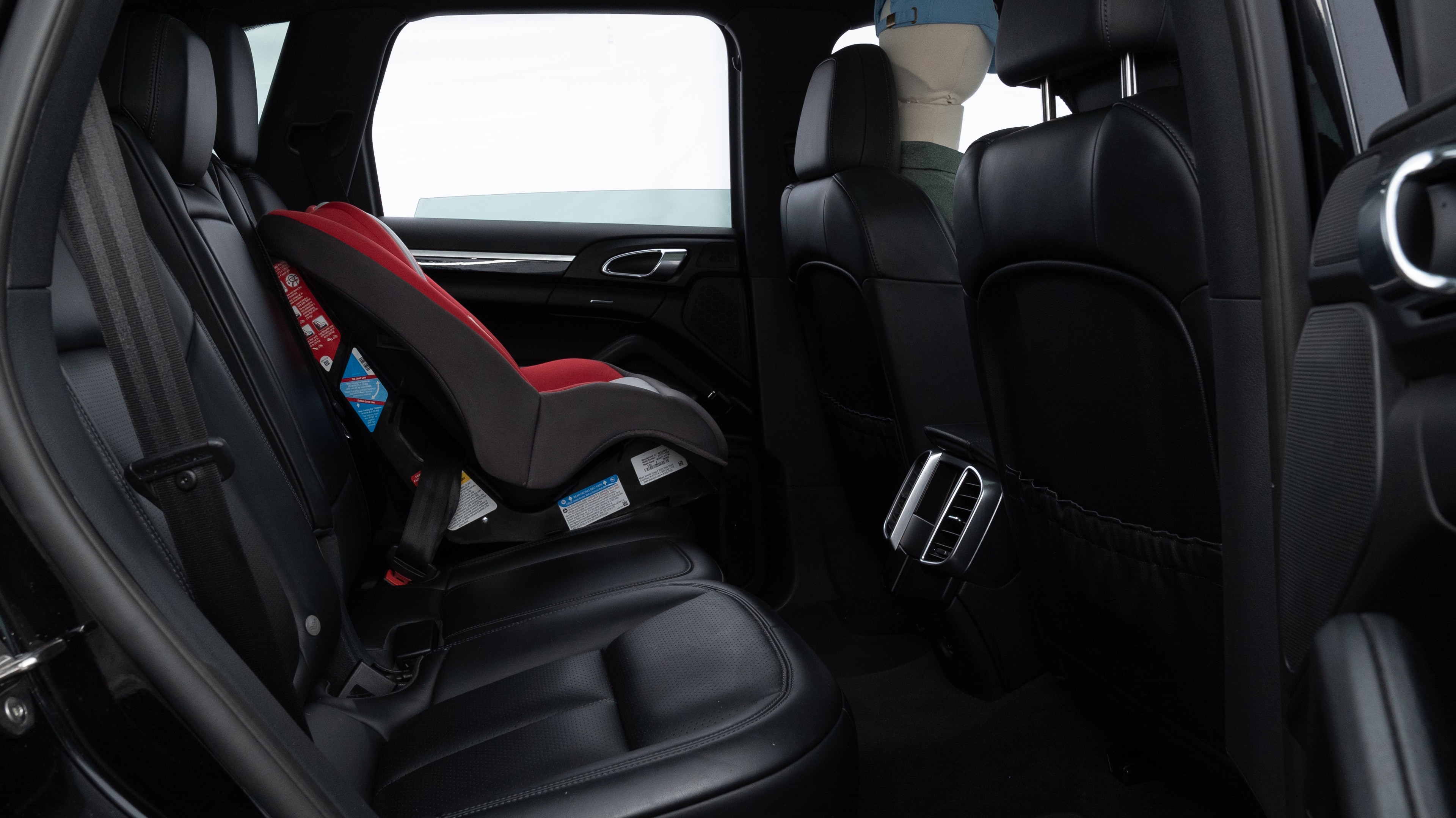 A series of second-row backseat photos is shown including one seating a baby seat and one seating a 6'1" mannequin.