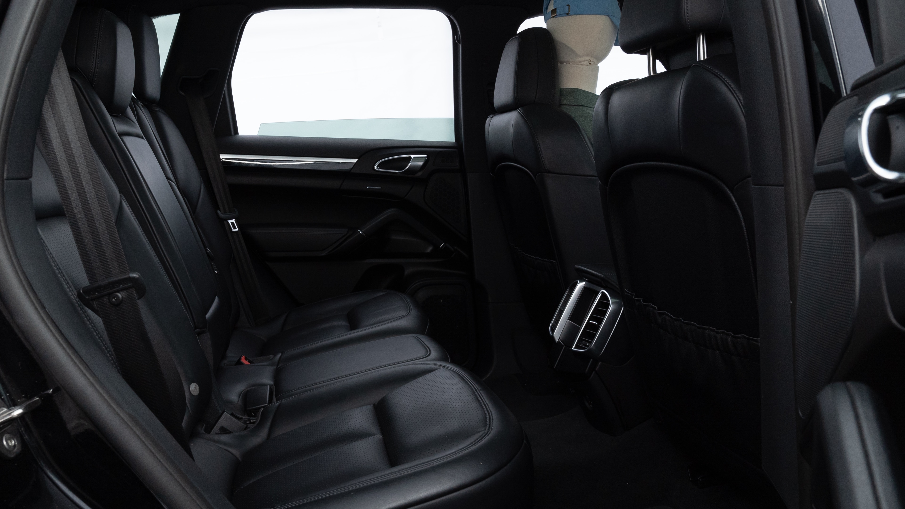 A series of second-row backseat photos is shown including one seating a baby seat and one seating a 6'1" mannequin.