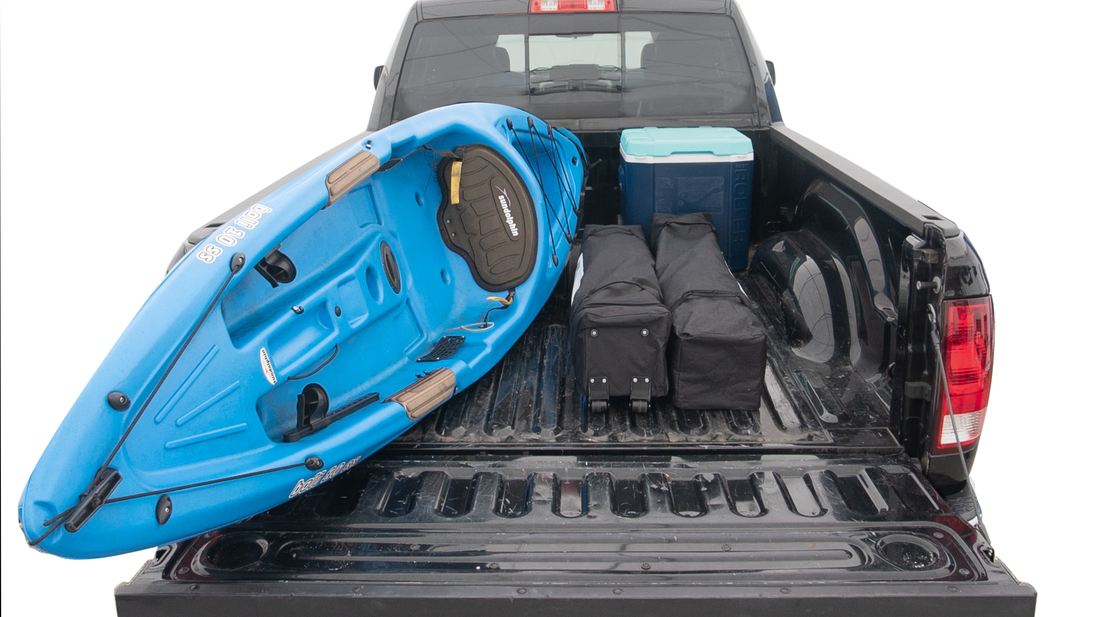 The trunk area is open giving a full view of the trunk area. A cooler, two camping chairs, two tailgate tent and a kayak are placed inside. 