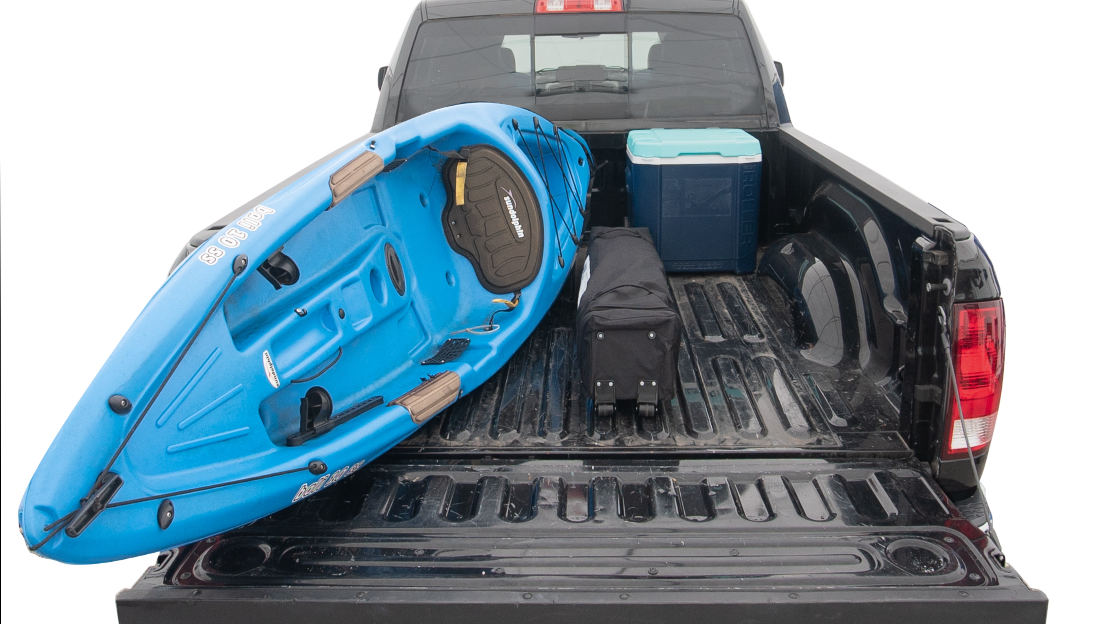 The trunk area is open giving a full view of the trunk area. A cooler, two camping chairs, two tailgate tent and a kayak are placed inside. 