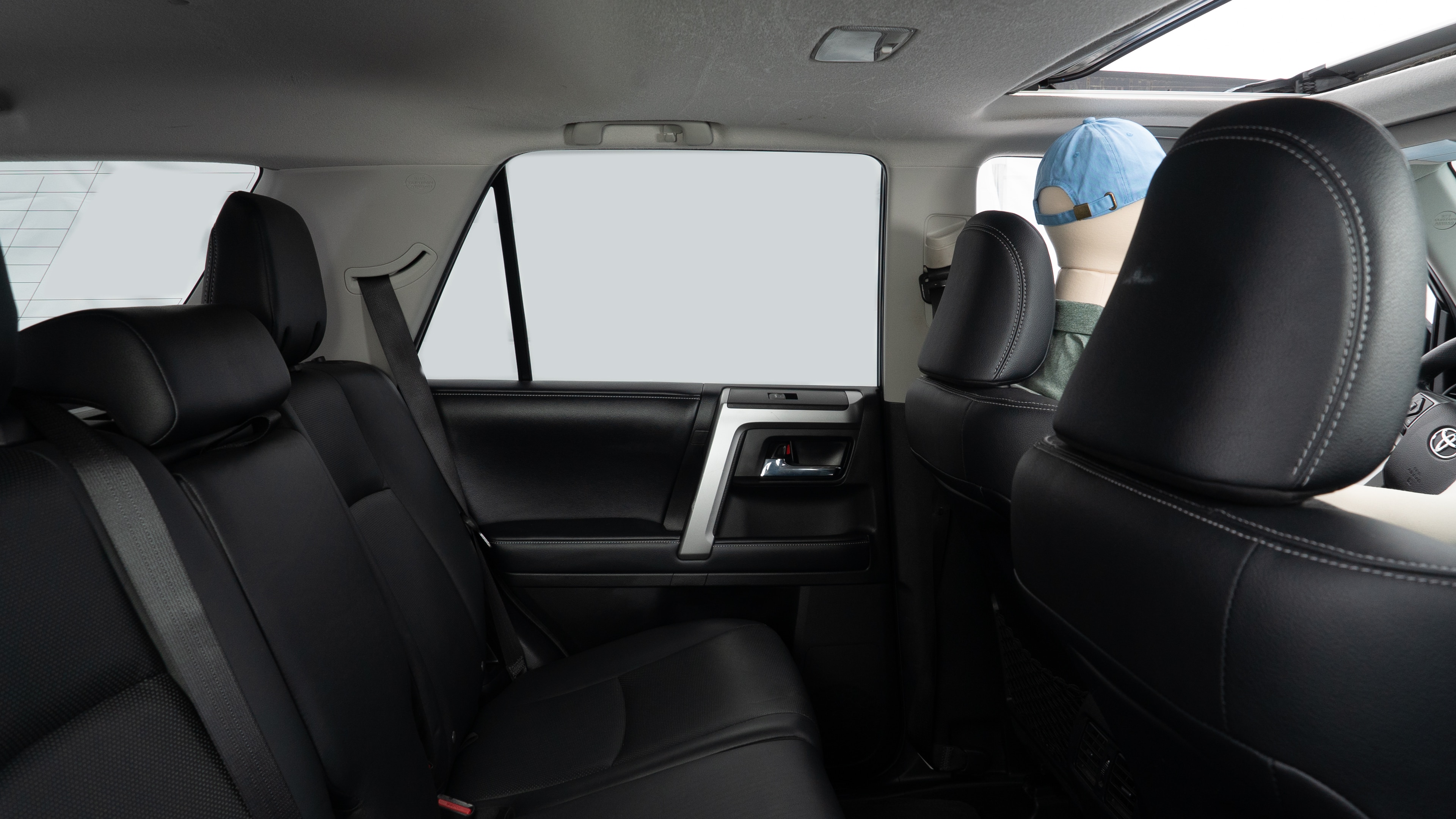 A series of second-row backseat photos is shown including one seating a baby seat and one seating a 6'1" mannequin.