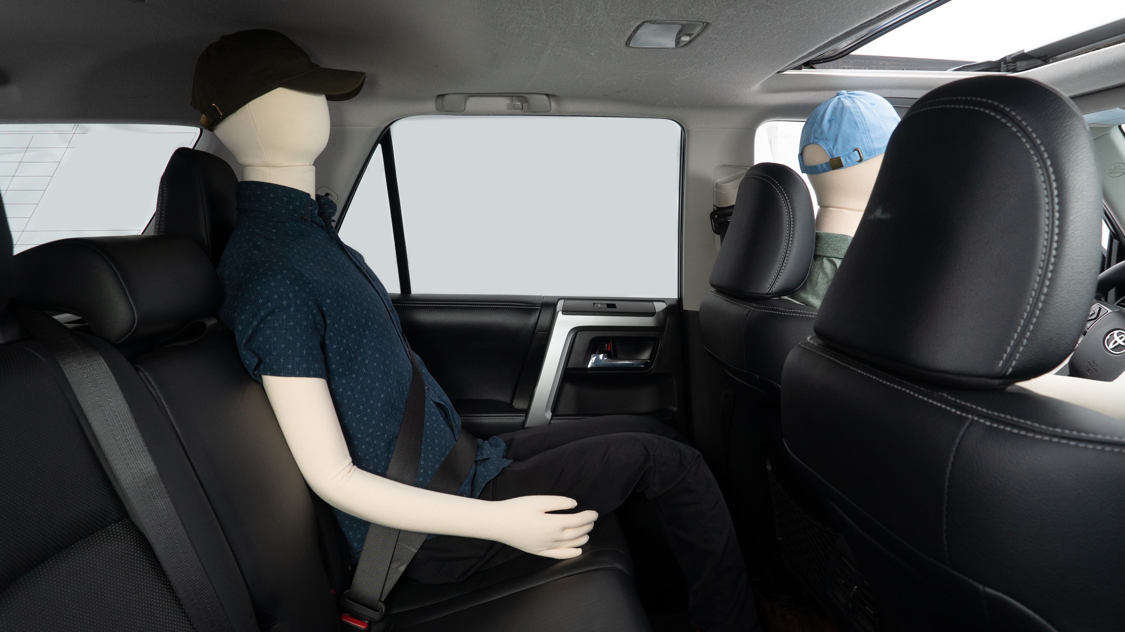 A series of second-row backseat photos is shown including one seating a baby seat and one seating a 6'1" mannequin.