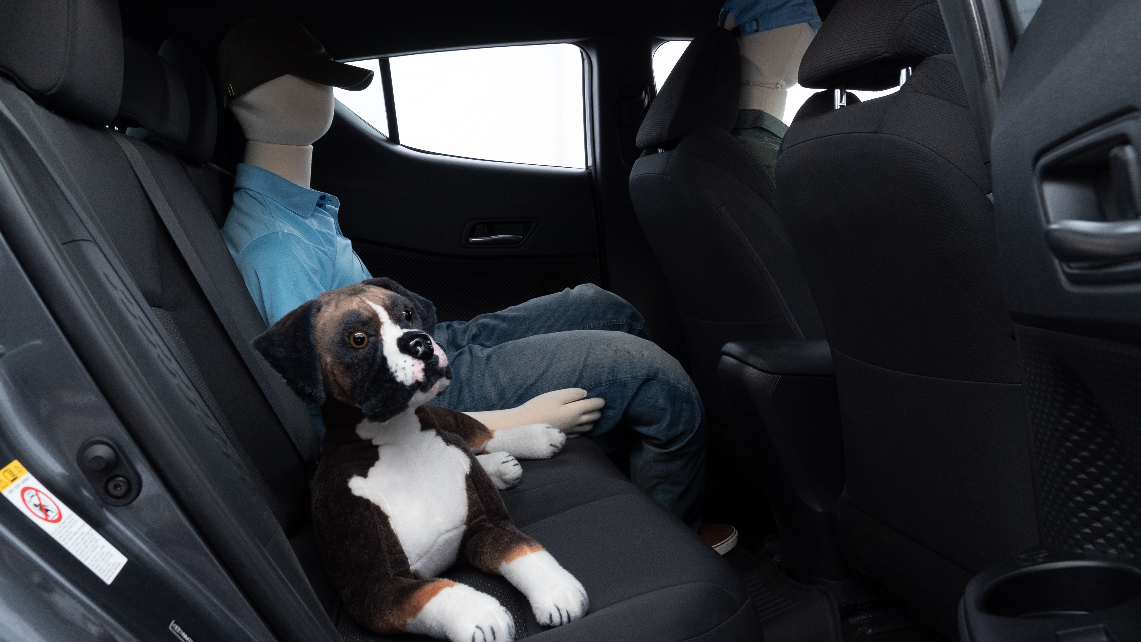 A series of second-row backseat photos is shown including one seating a baby seat and one seating a 6'1" mannequin.