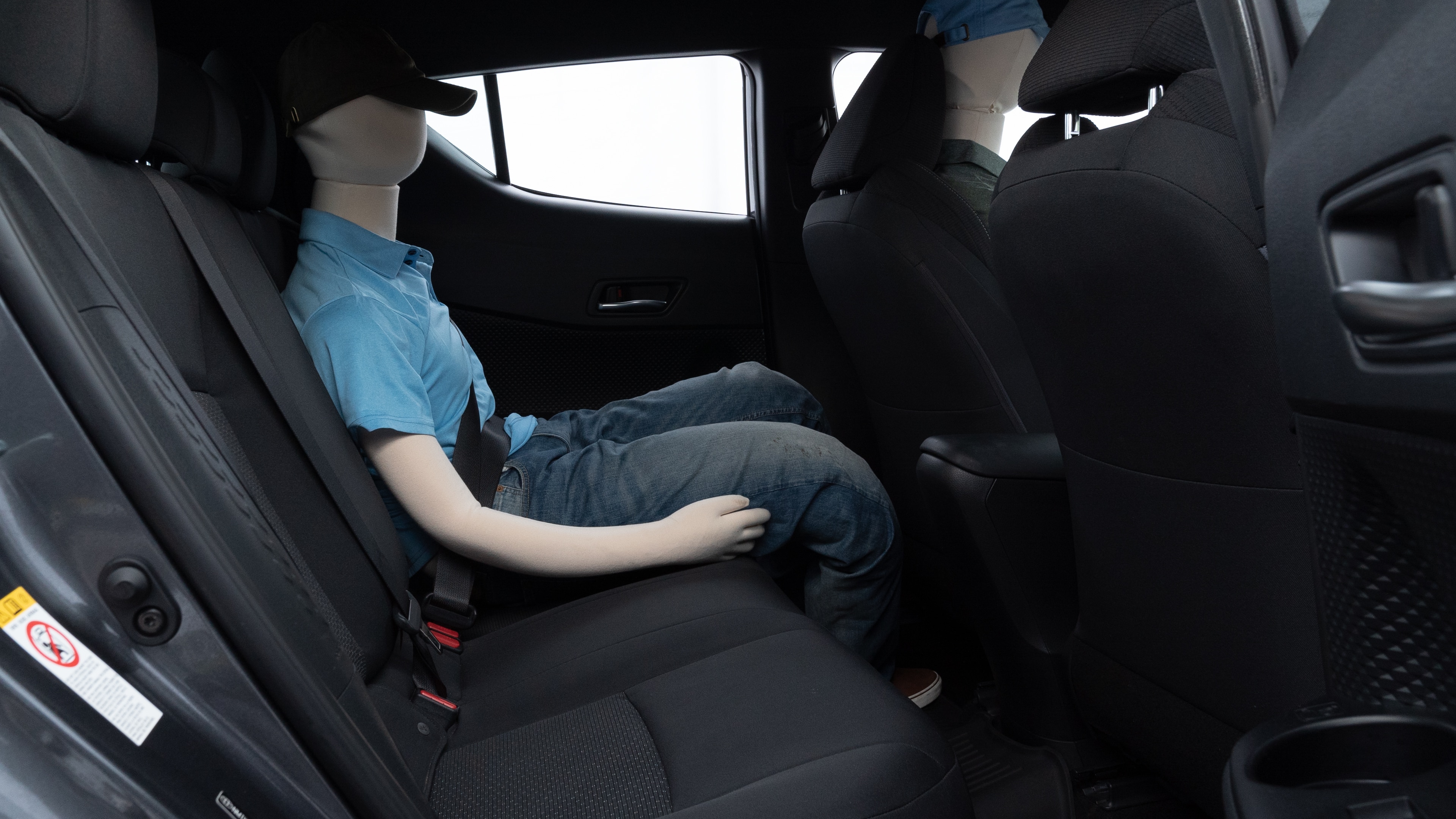 A series of second-row backseat photos is shown including one seating a baby seat and one seating a 6'1" mannequin.