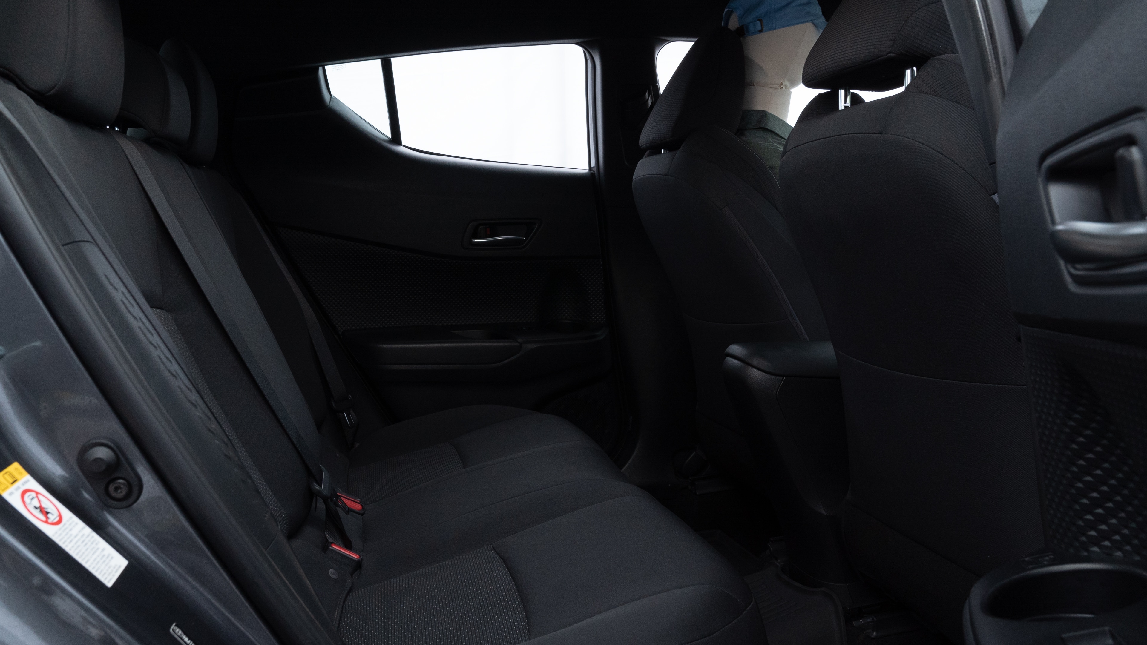 A series of second-row backseat photos is shown including one seating a baby seat and one seating a 6'1" mannequin.