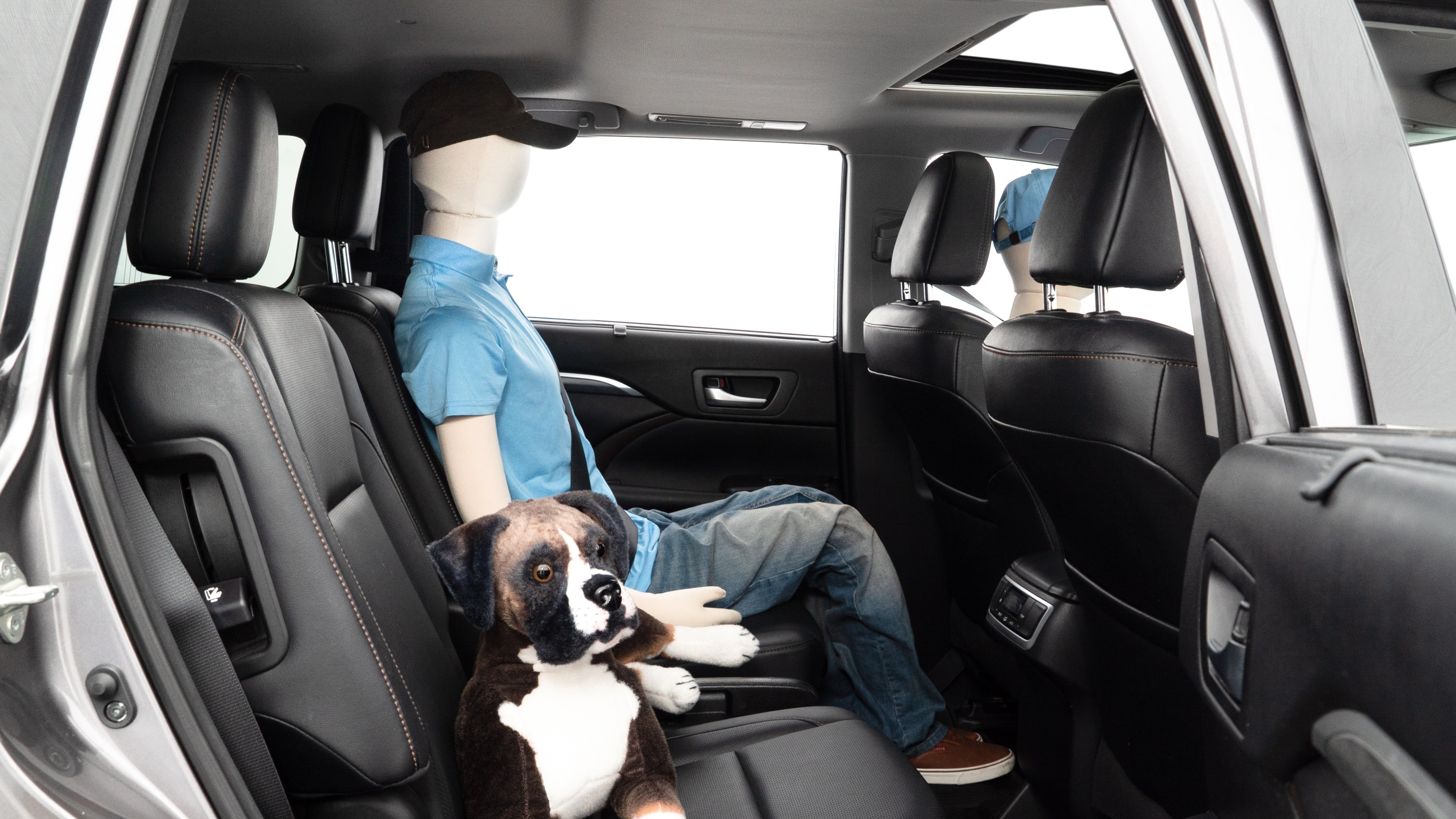 A series of second-row backseat photos is shown including one seating a baby seat and one seating a 6'1" mannequin.