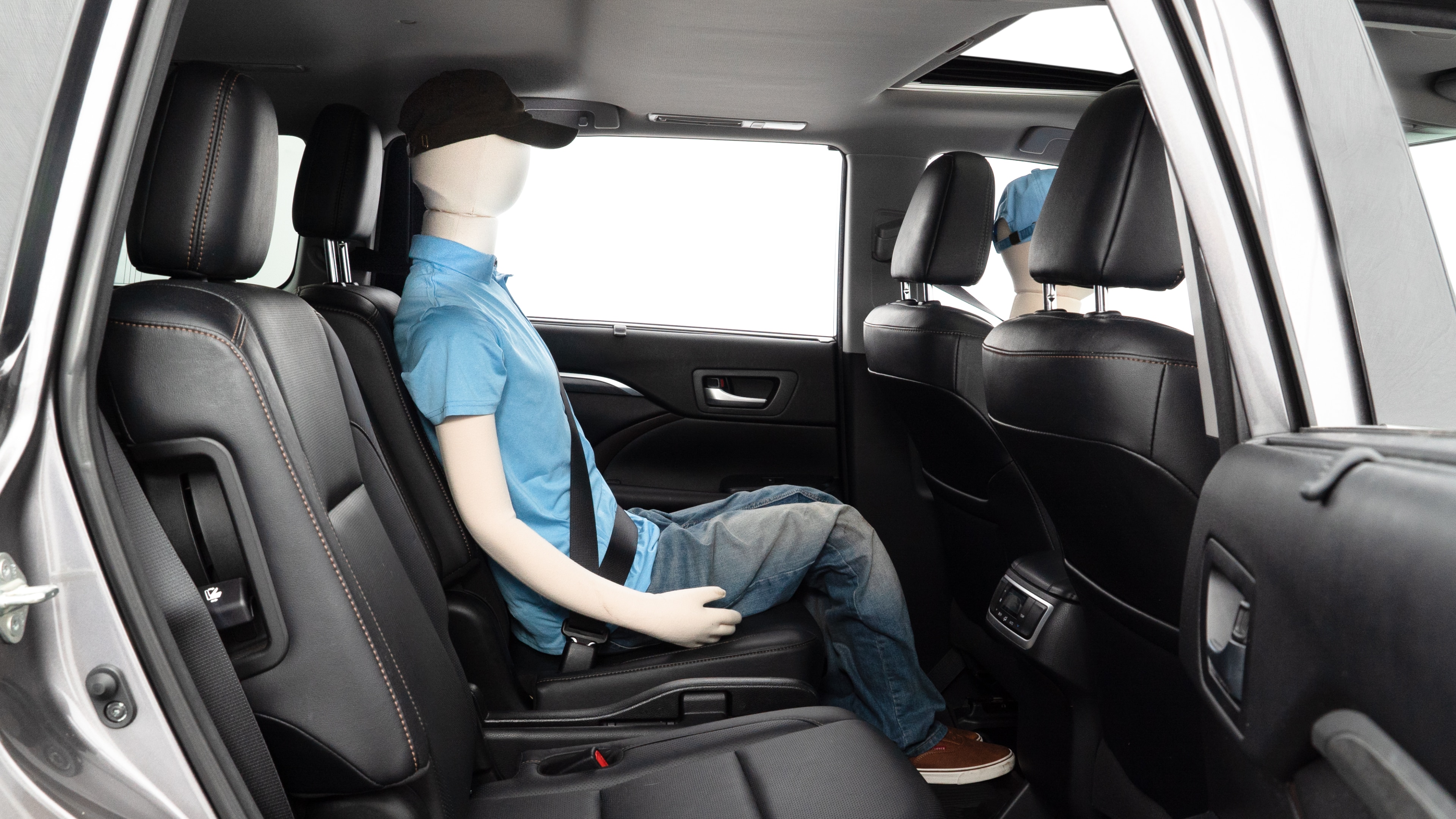 A series of second-row backseat photos is shown including one seating a baby seat and one seating a 6'1" mannequin.