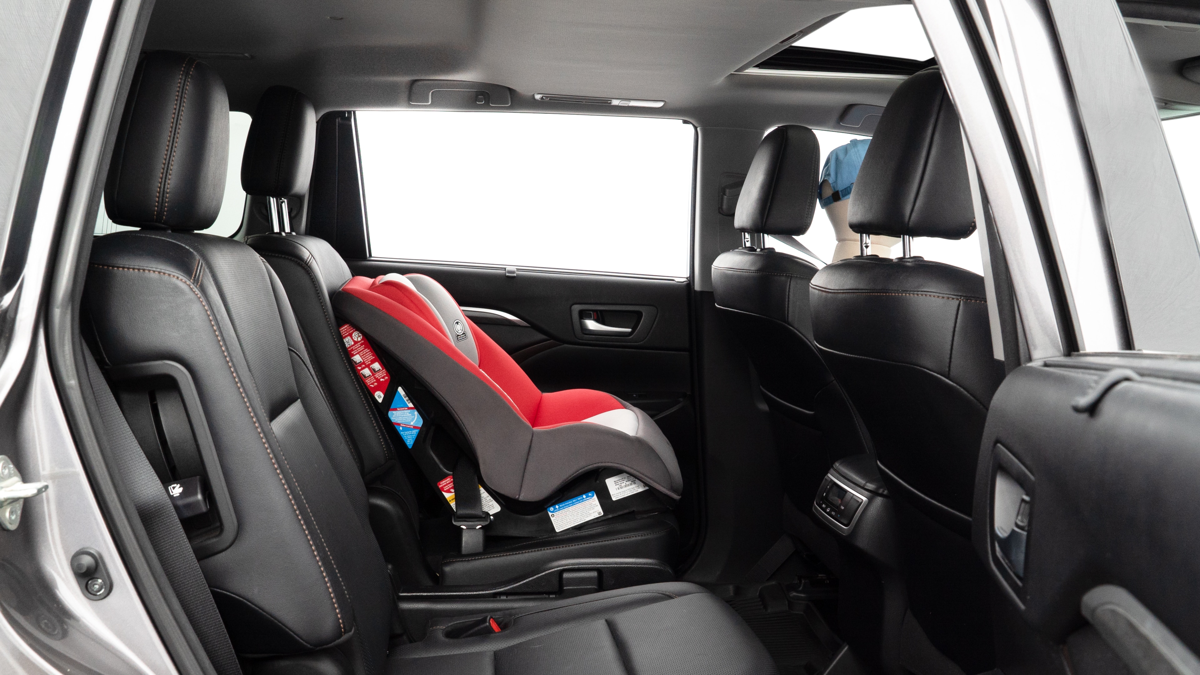 A series of second-row backseat photos is shown including one seating a baby seat and one seating a 6'1" mannequin.