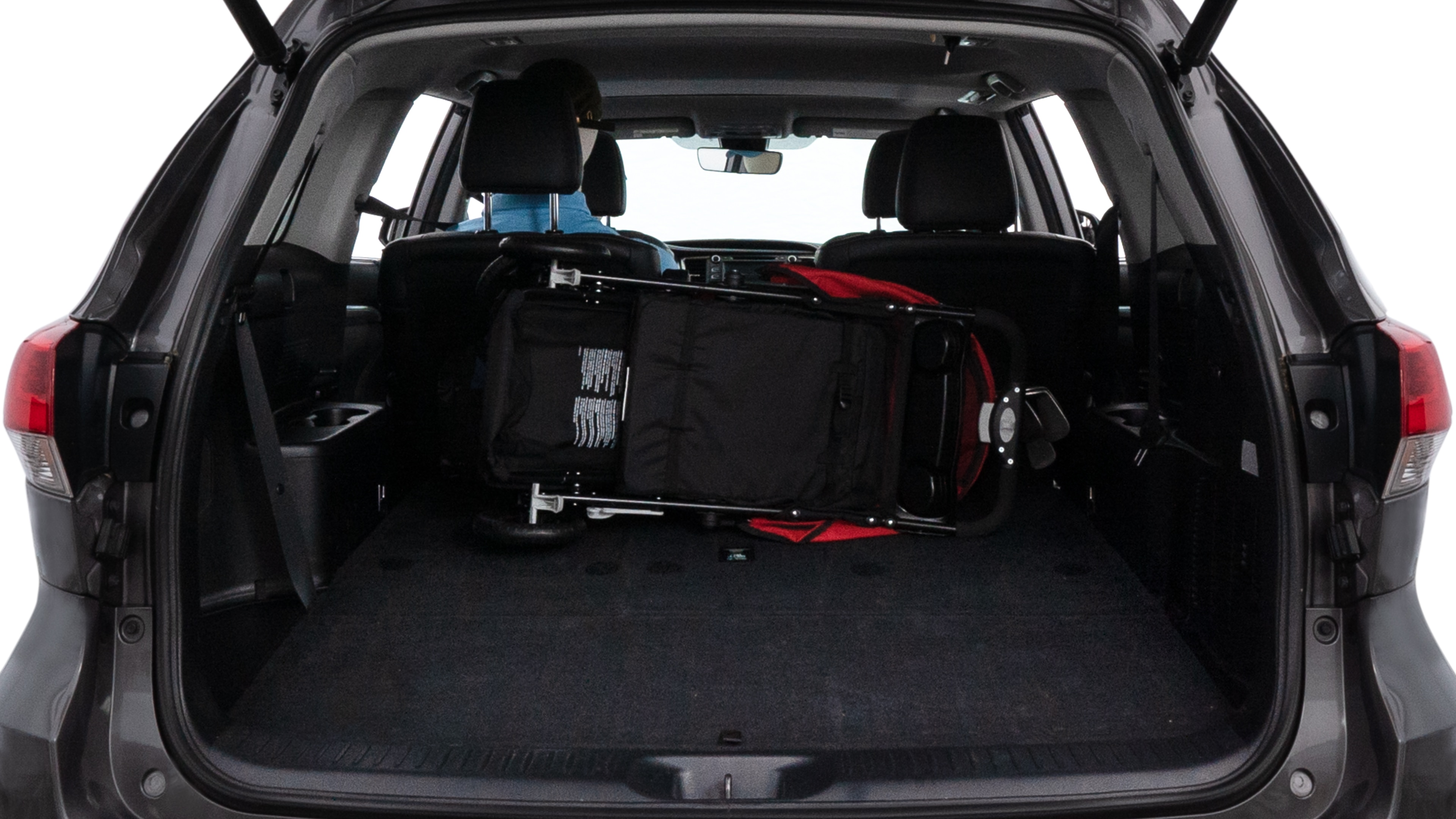 The trunk lid is open showing full view of the trunk. A baby stroller, three grocery carriers, two camping chairs in the carrying bag, and a set of golf clubs are placed inside.