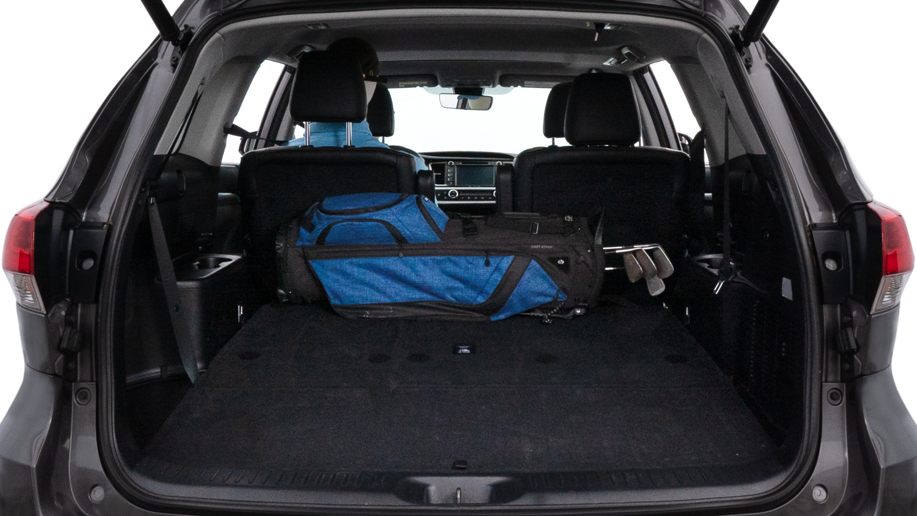 The trunk lid is open showing full view of the trunk. A baby stroller, three grocery carriers, two camping chairs in the carrying bag, and a set of golf clubs are placed inside.