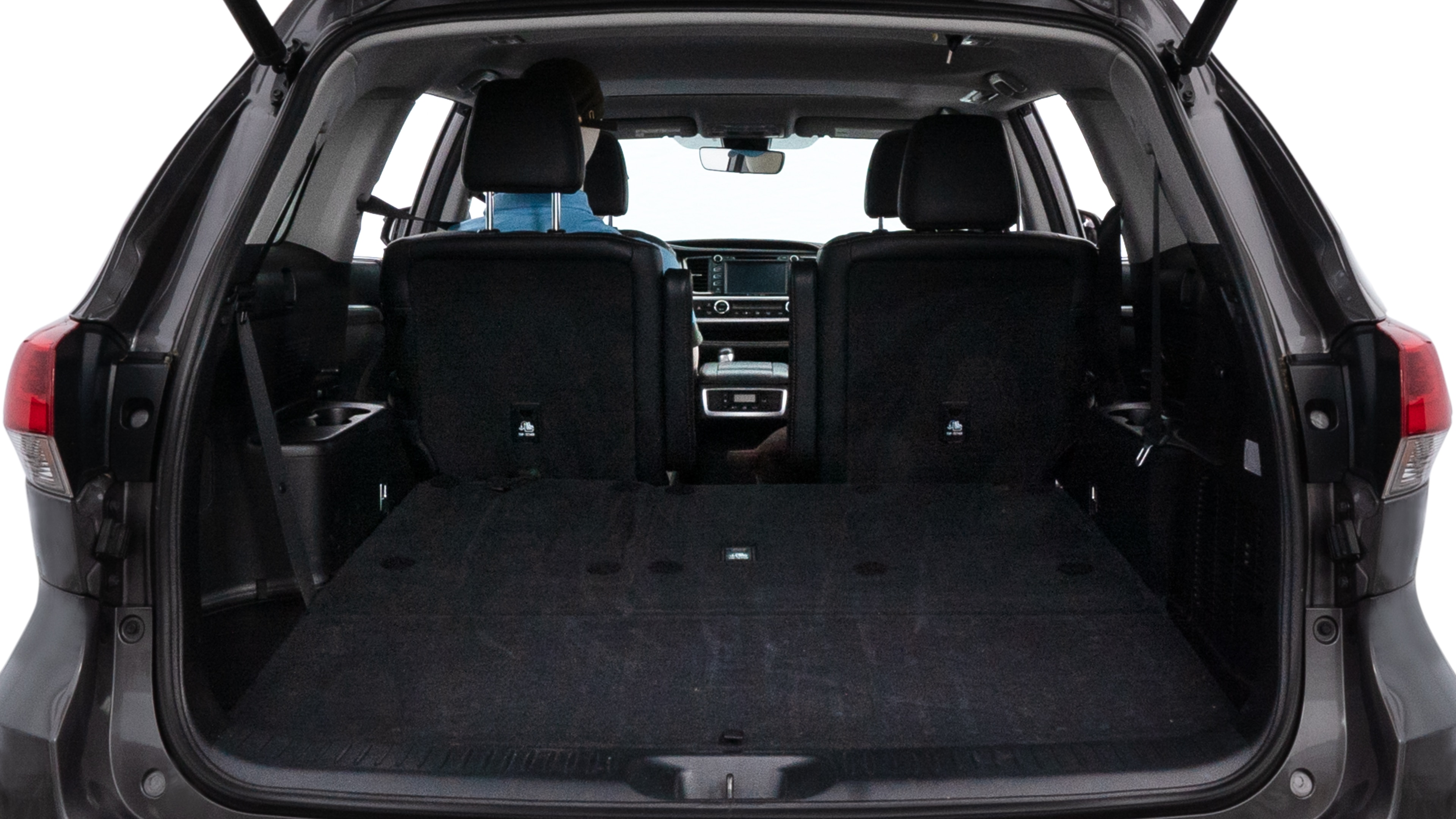 The trunk lid is open, showing full view of the trunk space. One large suitcase, two medium suitcases, and two small suitcases are placed inside.