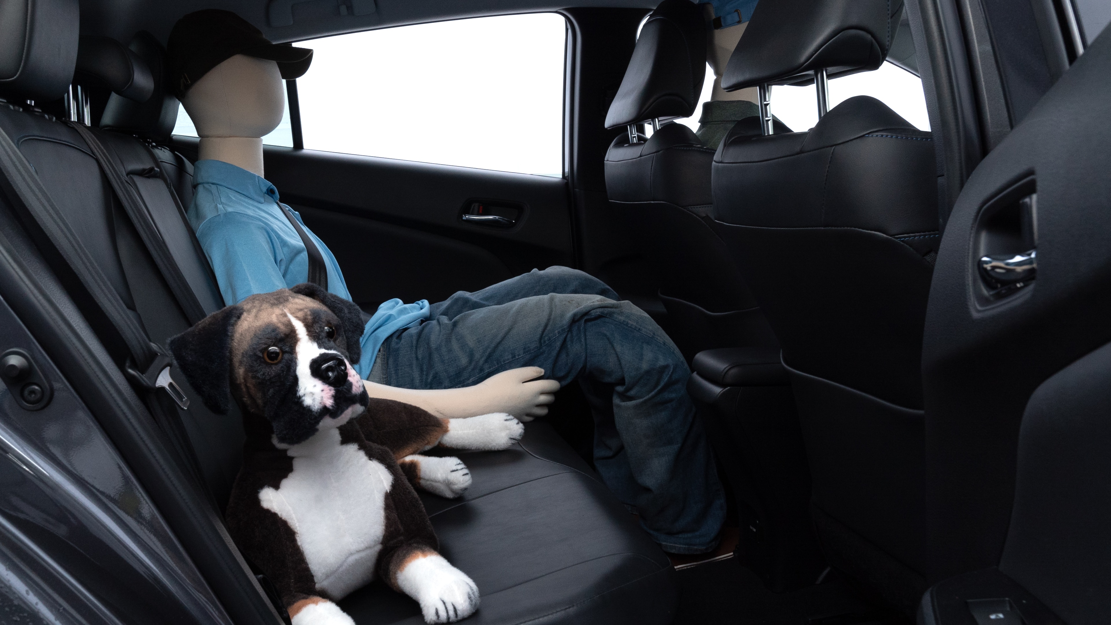 A series of second-row backseat photos is shown including one seating a baby seat and one seating a 6'1" mannequin.