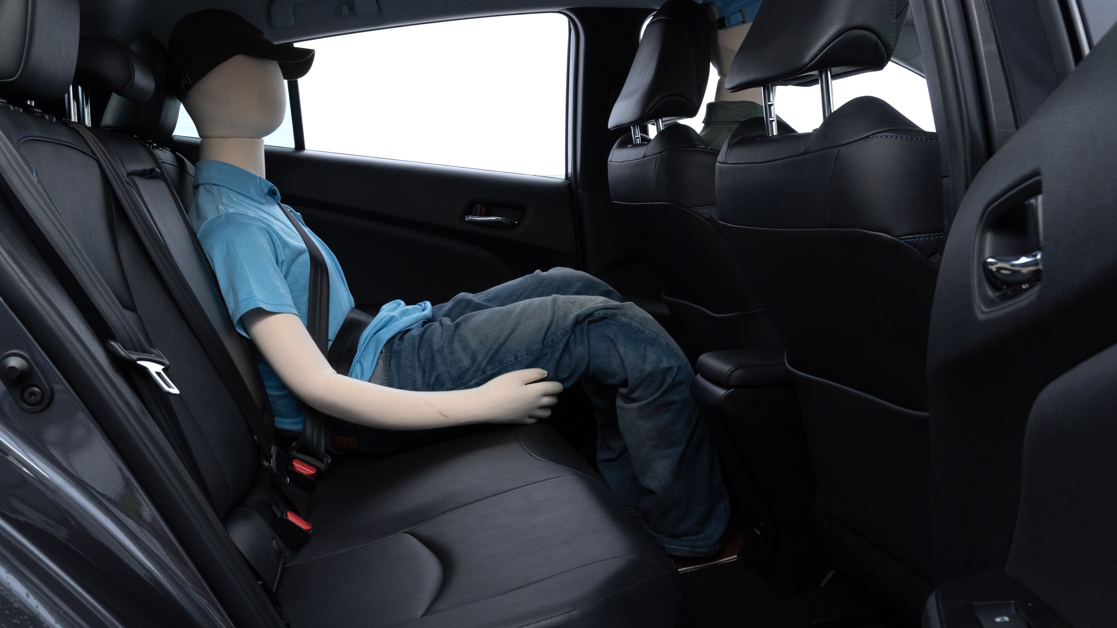 A series of second-row backseat photos is shown including one seating a baby seat and one seating a 6'1" mannequin.