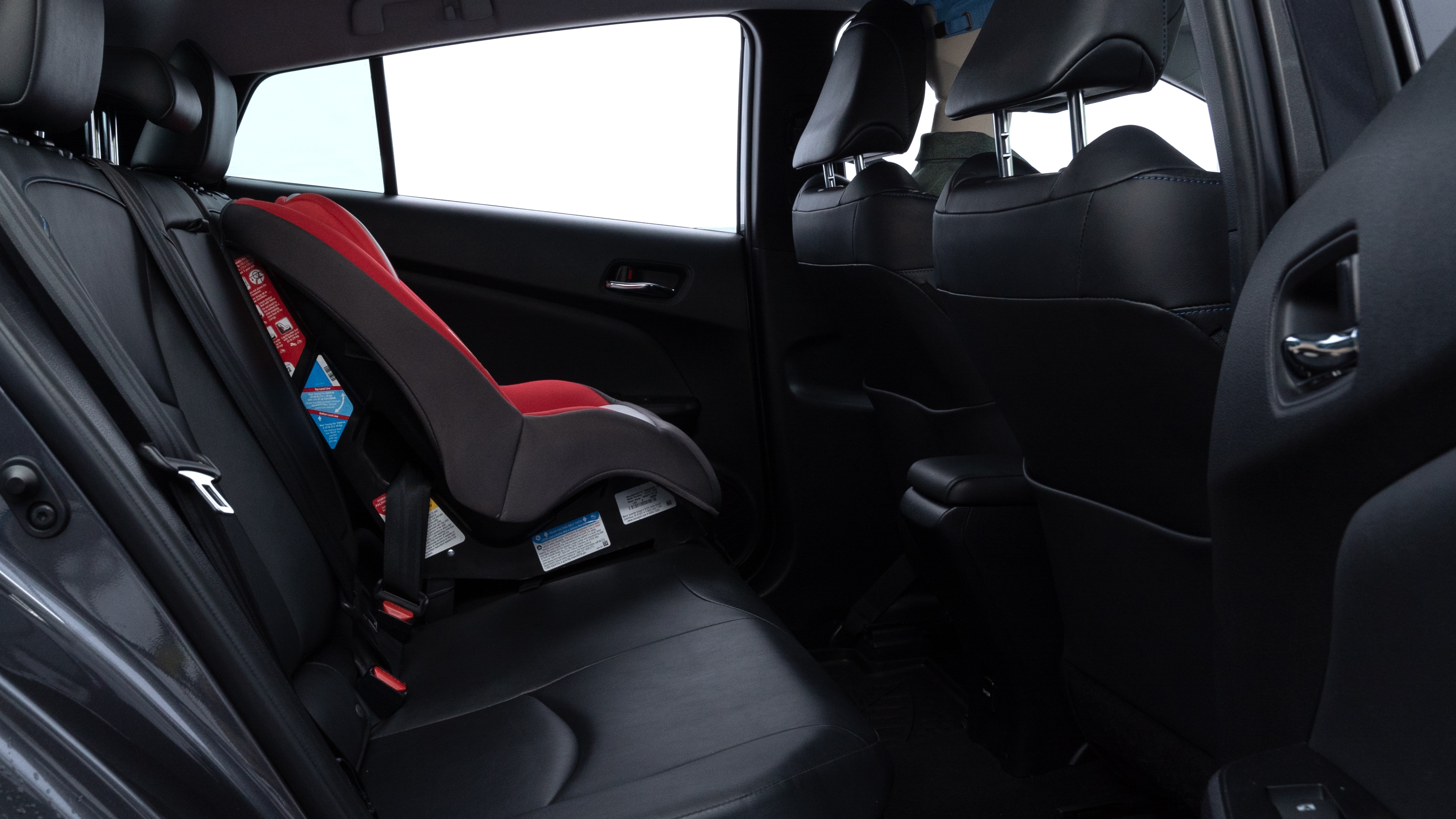 A series of second-row backseat photos is shown including one seating a baby seat and one seating a 6'1" mannequin.