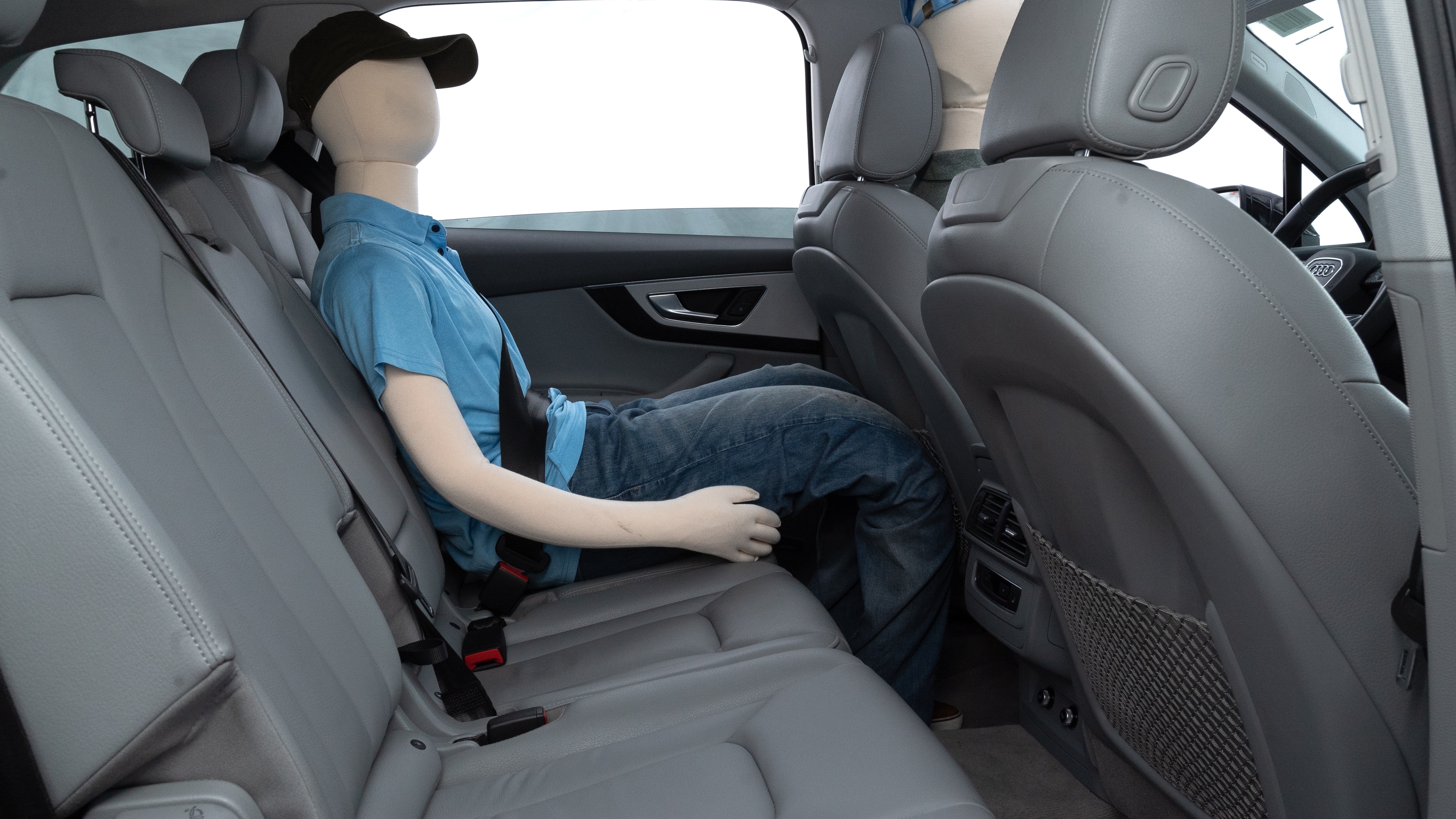 A series of second-row backseat photos is shown including one seating a baby seat and one seating a 6'1" mannequin.