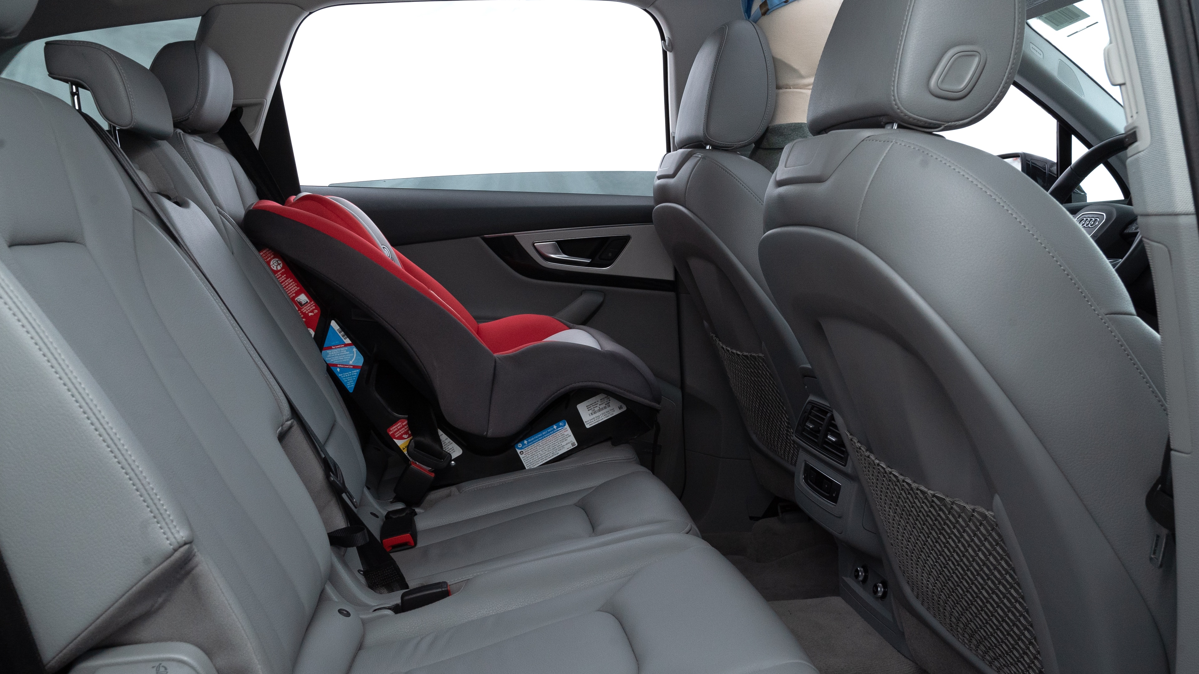 A series of second-row backseat photos is shown including one seating a baby seat and one seating a 6'1" mannequin.