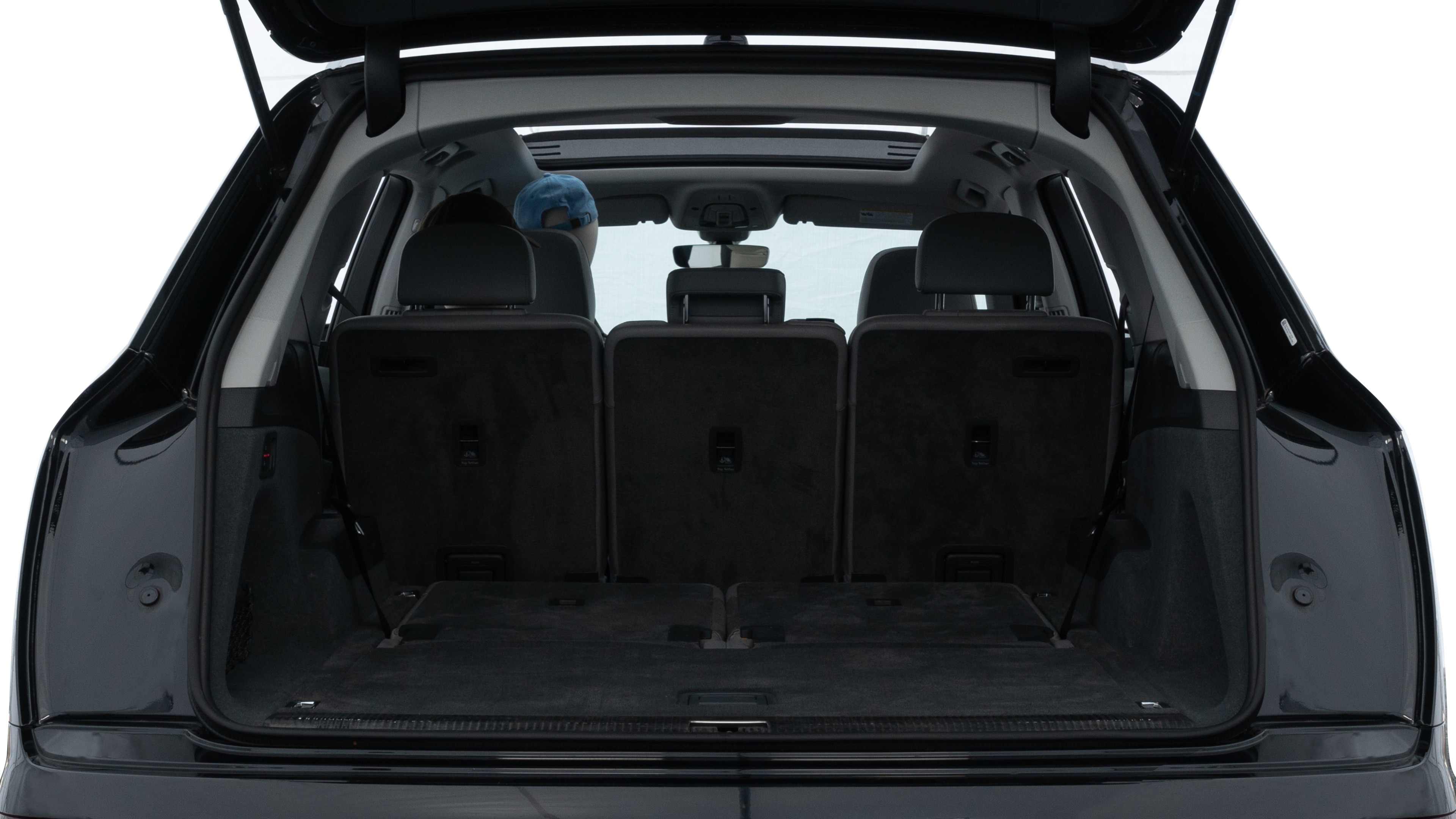 The trunk lid is open showing full view of the trunk. A baby stroller, three grocery carriers, two camping chairs in the carrying bag, and a set of golf clubs are placed inside.