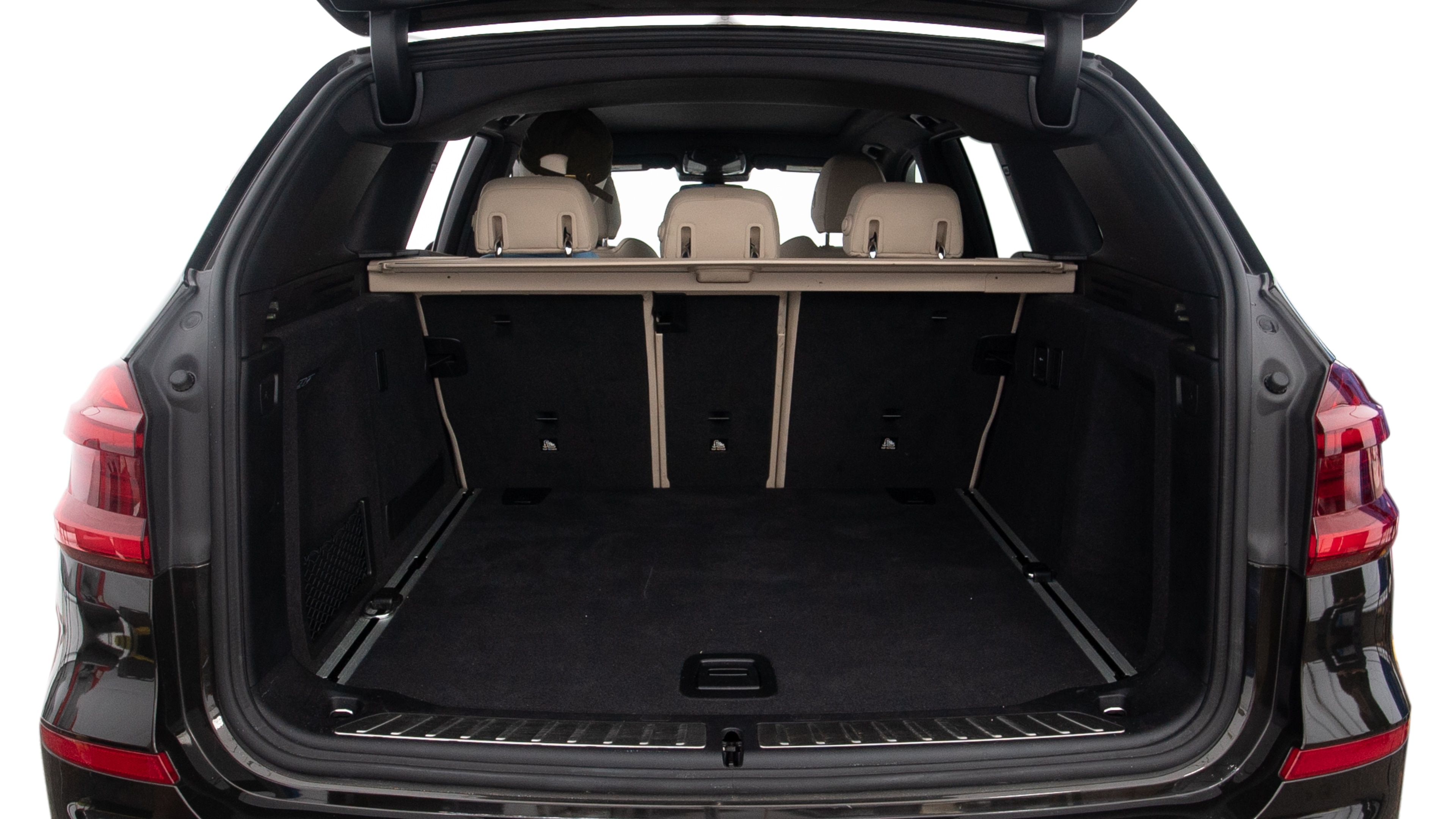 The trunk lid is open showing full view of the trunk. A baby stroller, three grocery carriers, two camping chairs in the carrying bag, and a set of golf clubs are placed inside.