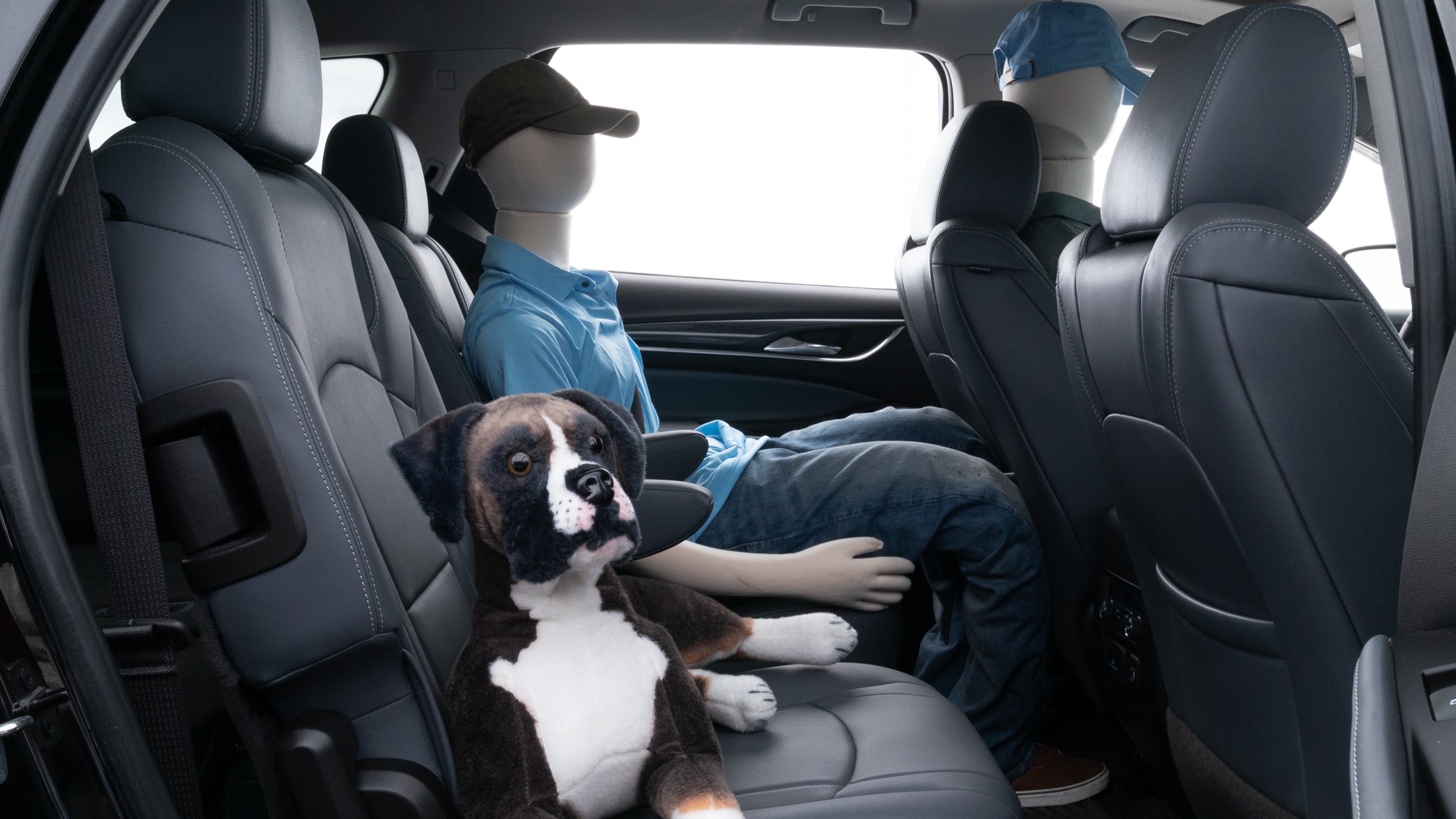 A series of second-row backseat photos is shown including one seating a baby seat and one seating a 6'1" mannequin.