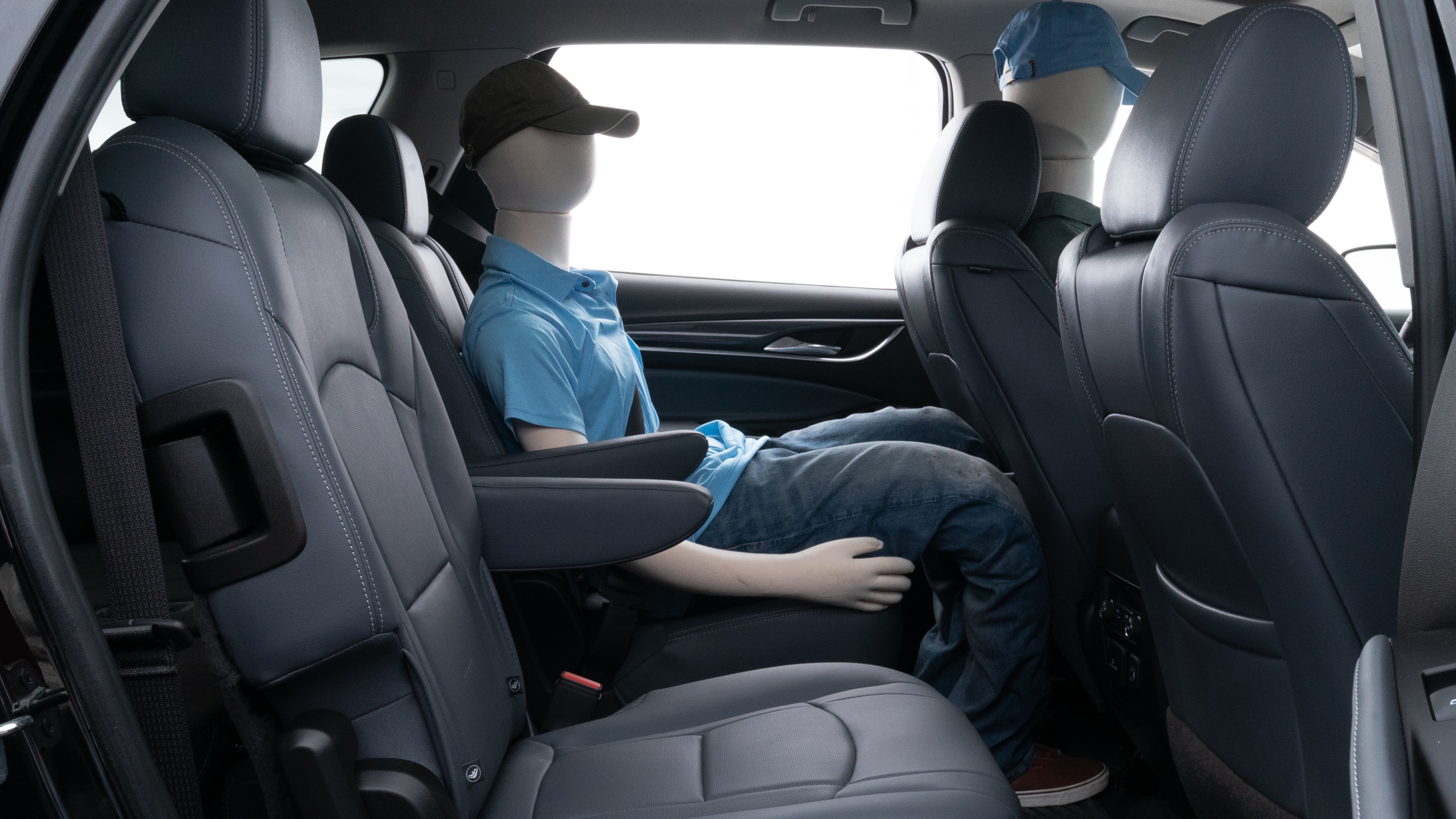 A series of second-row backseat photos is shown including one seating a baby seat and one seating a 6'1" mannequin.